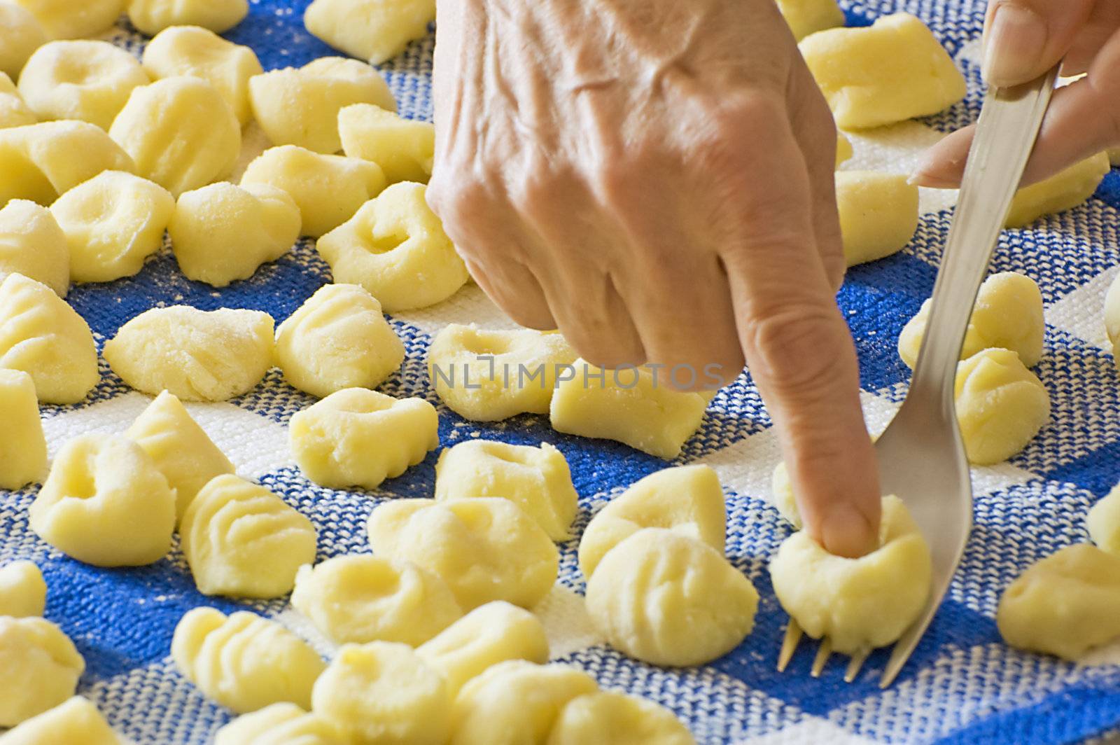 Making groove in gnocchi with fork