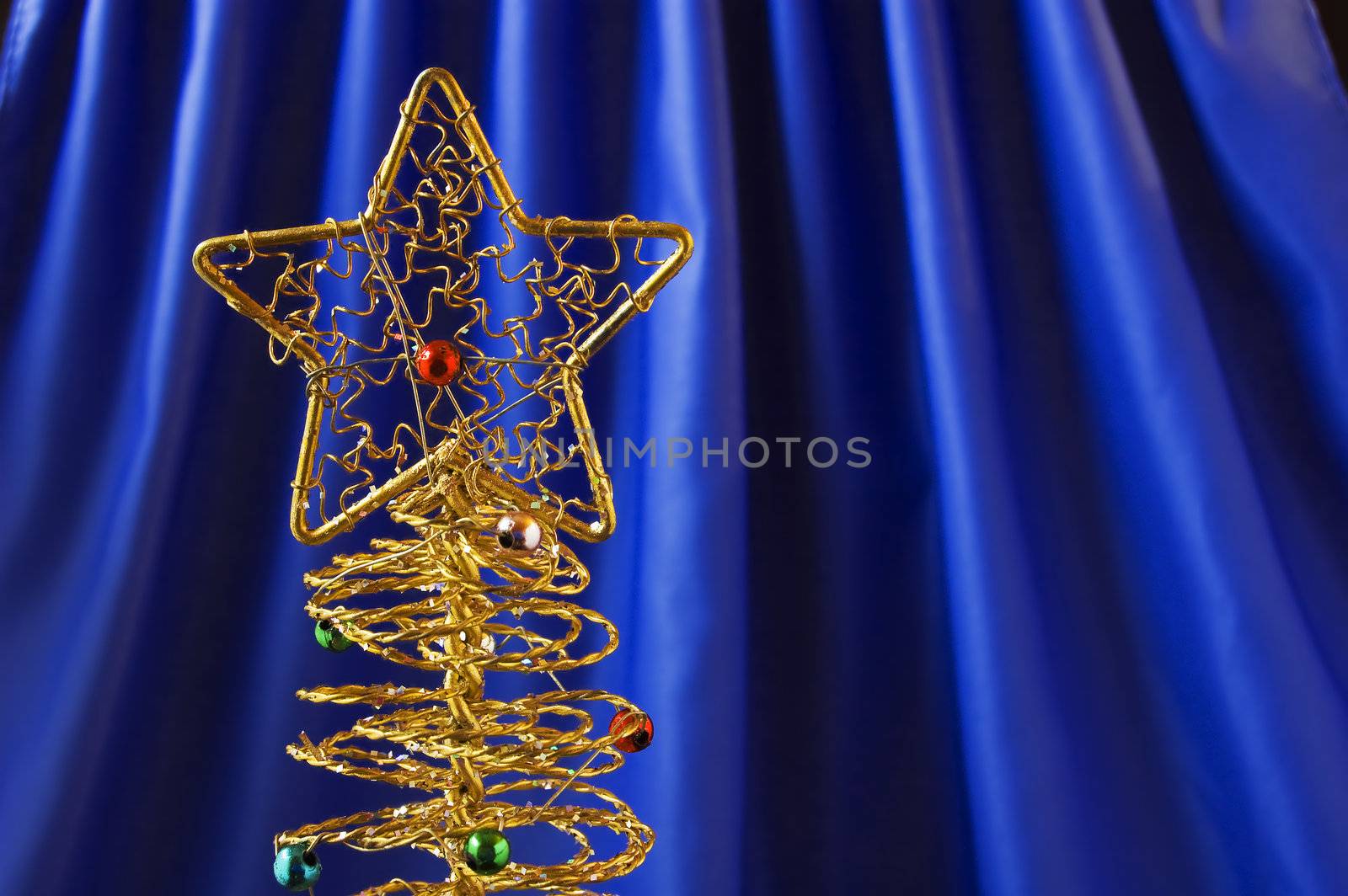 Metallic christmas tree on blue background