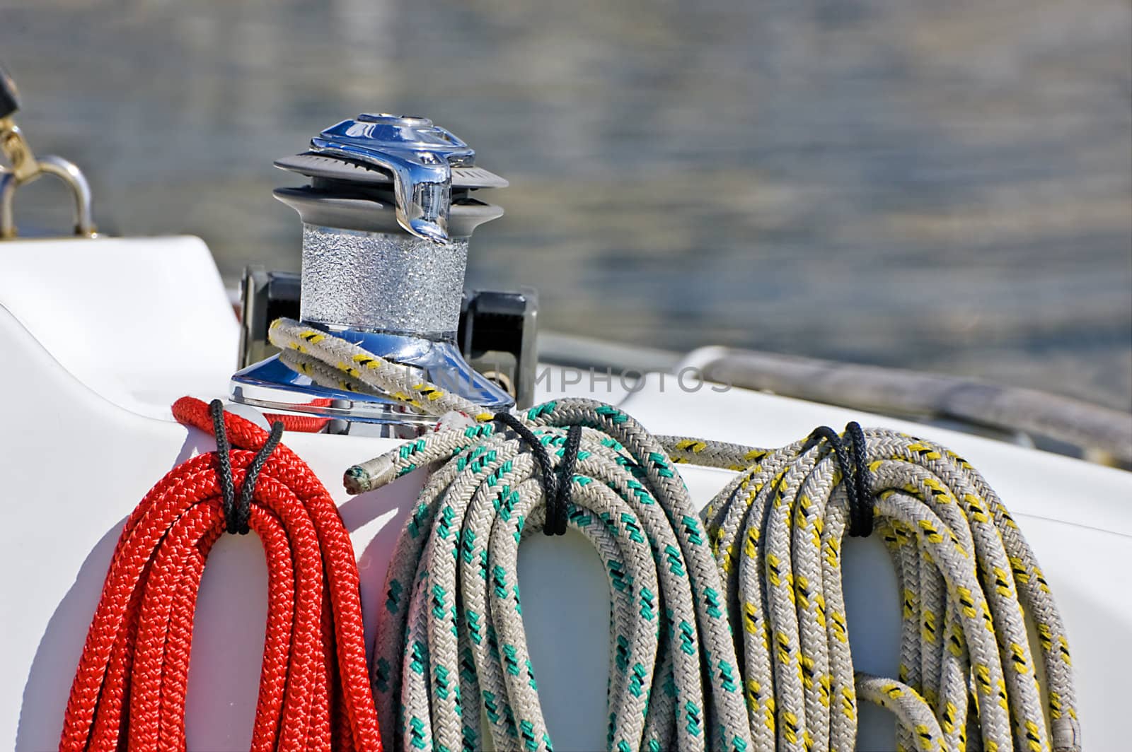 Three coloured ropes wrapped and tied on a sailing boat