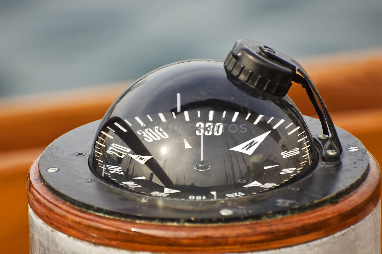 A big compass on a boat showing direction