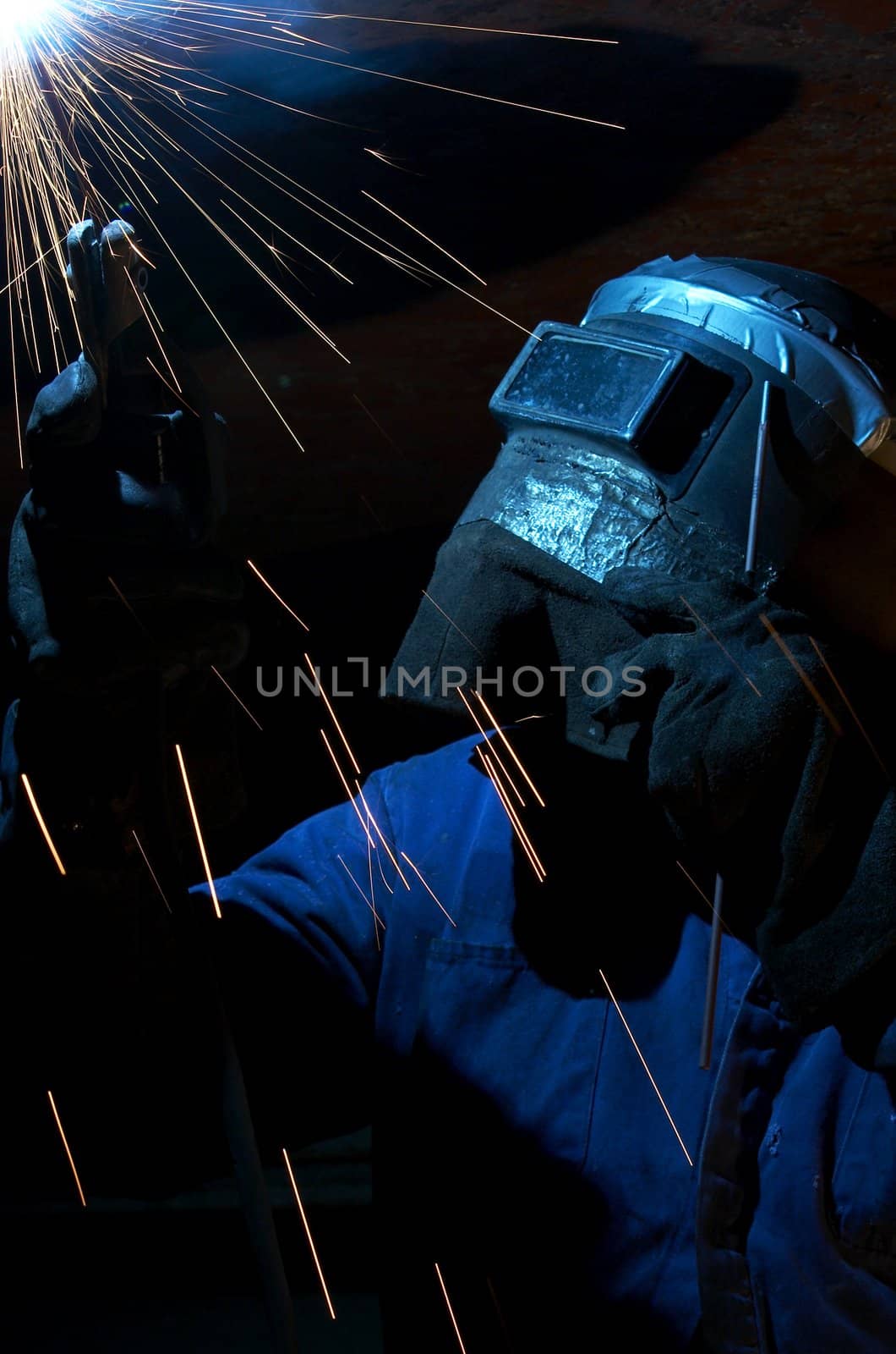 a welder working at shipyard at night