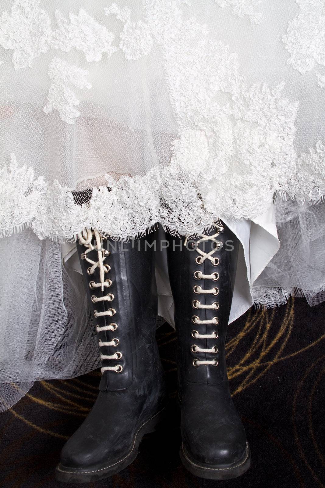 A bride wearing her wedding dress with boots.