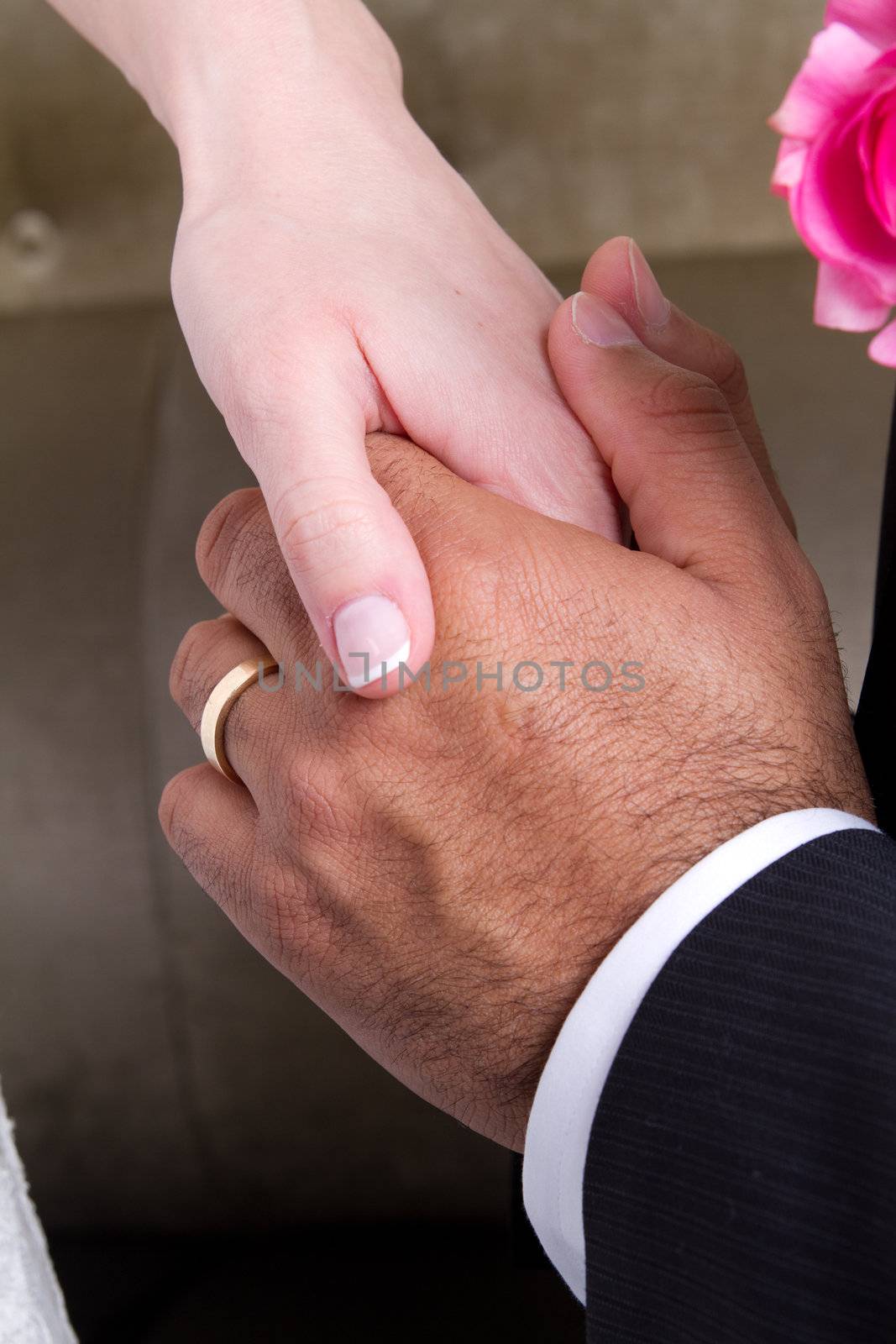 Newly wed couple holding hands and showing their love.