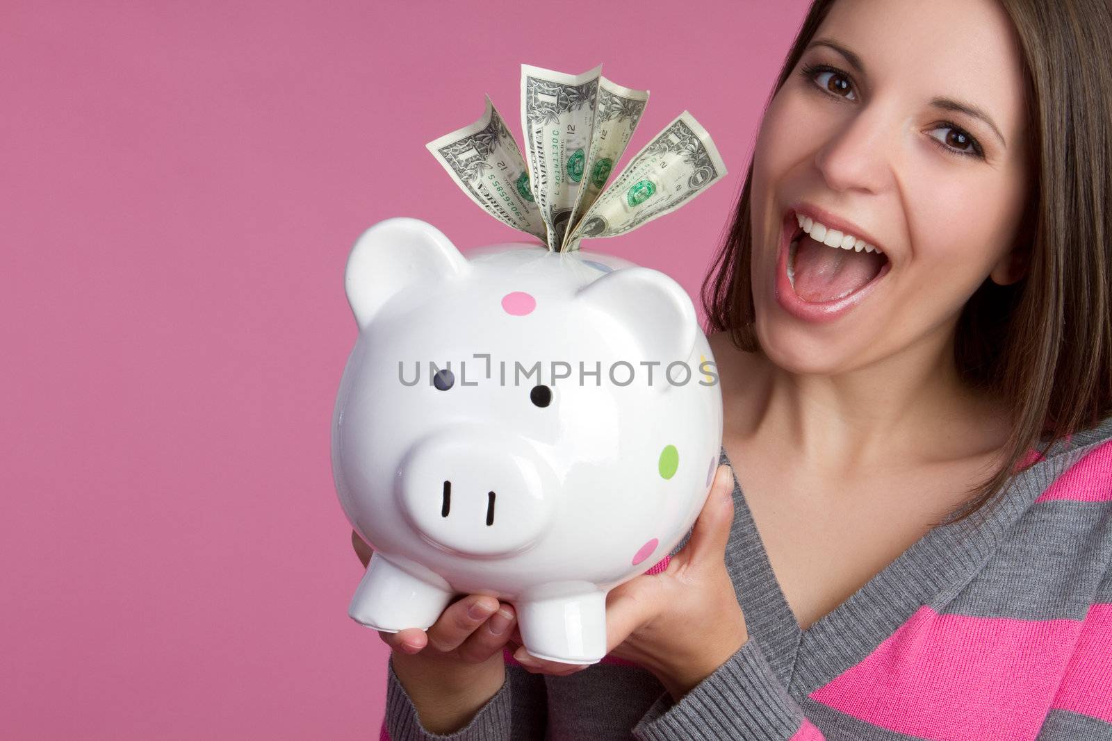 Smiling girl holding piggy bank