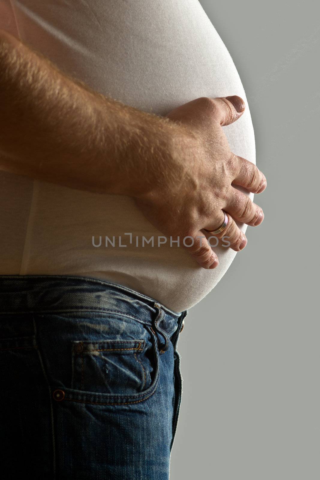 Overweight man with hand on belly by lavsen