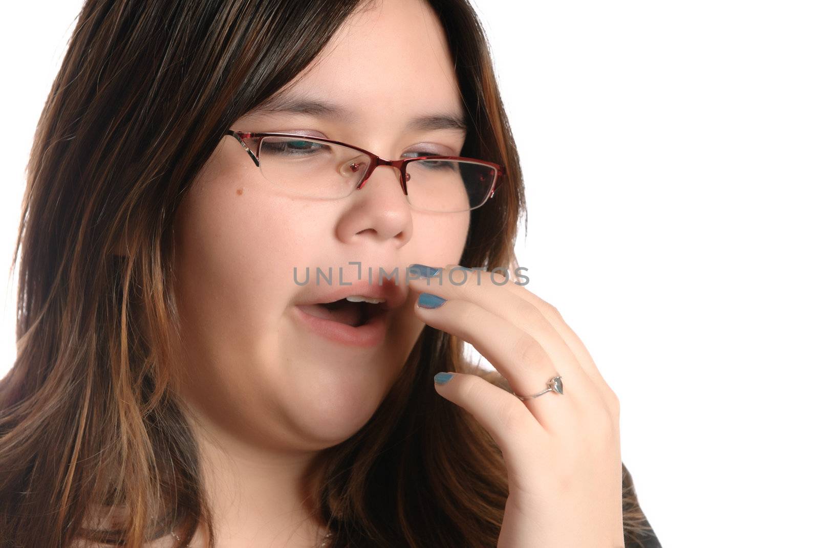 Closeup view of a yawning teenage girl, isolated against a white background