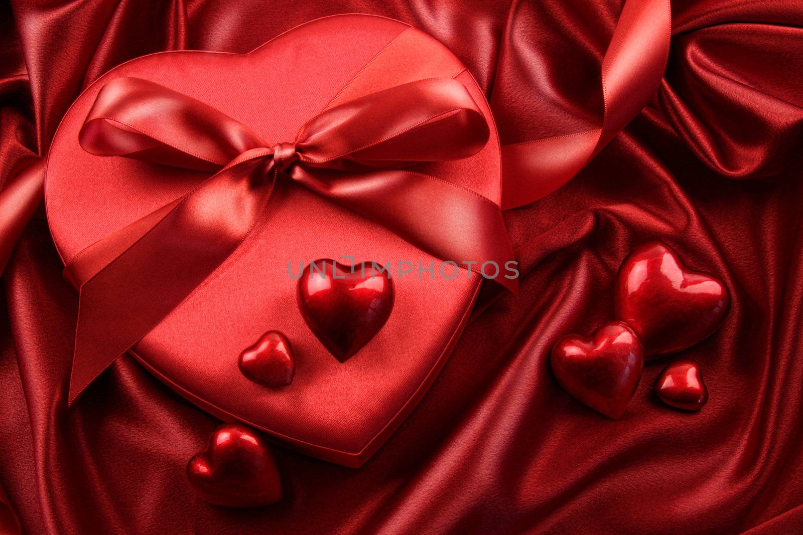 Box of chocolates with ribbons and hearts