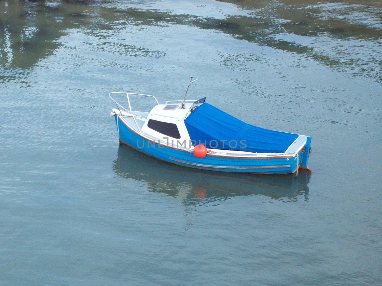 Photo of an isolated small blue boat