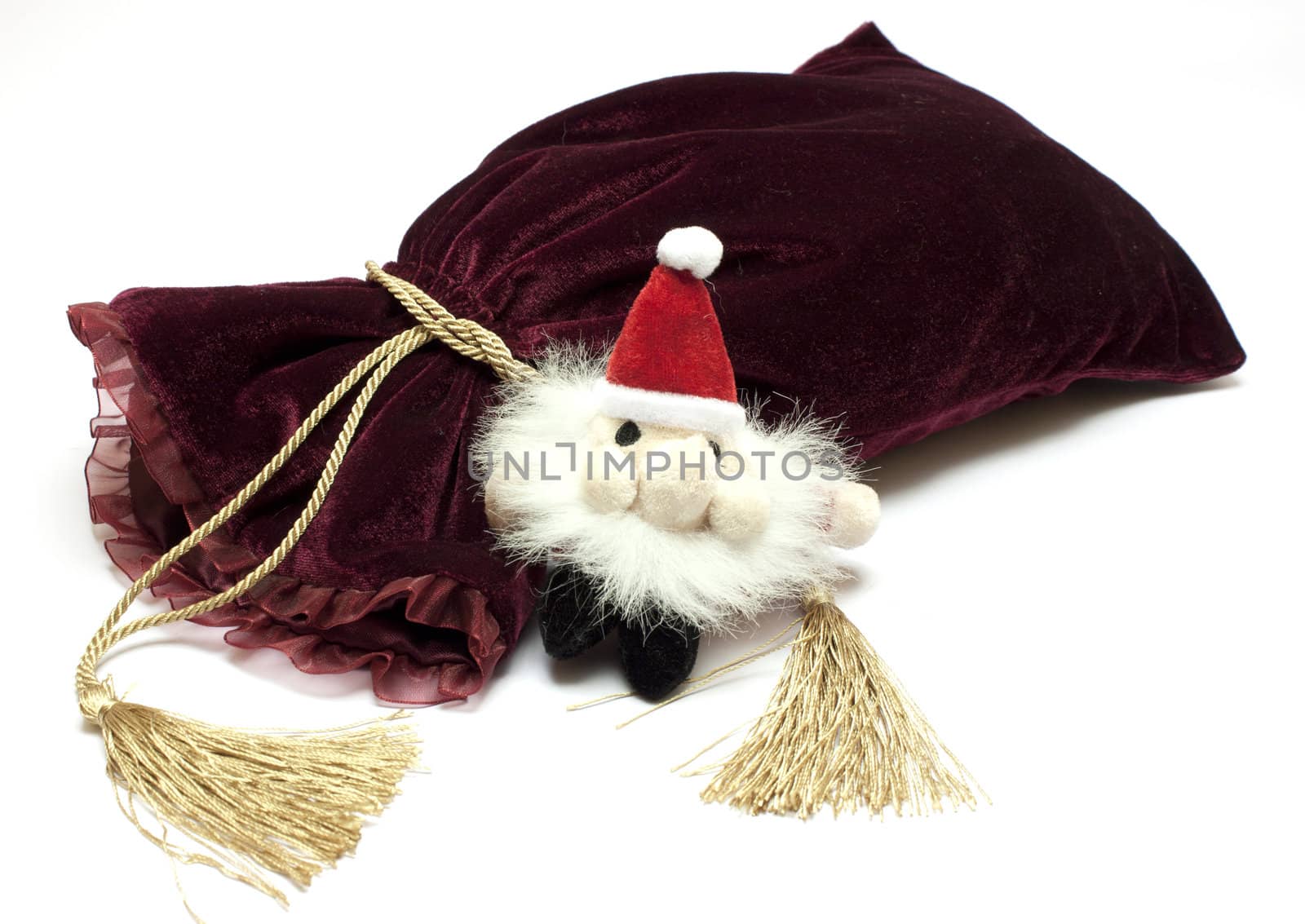 Santa Claus toy and fancy luxury gift bag over white background 