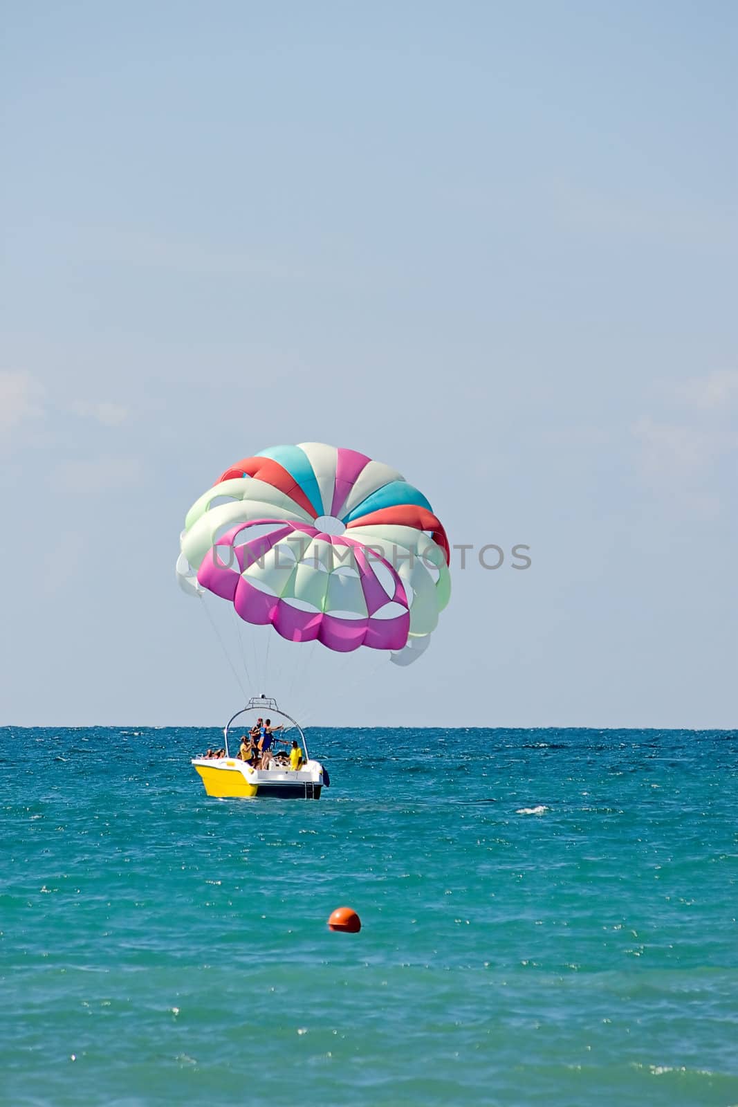 Motor boat with  parachute for parasailing on  background of sky and horizon.