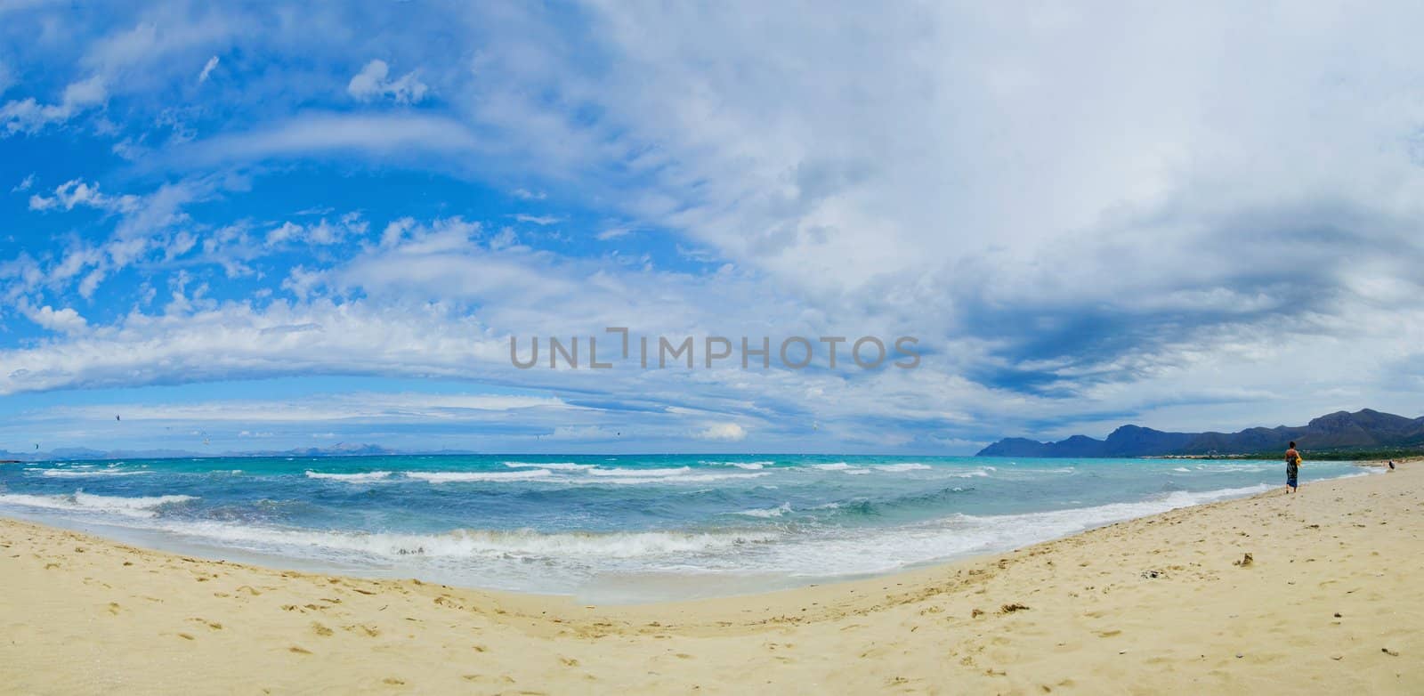 Beautiful blue Beach Mallorca panoramic sea view on a windy day. Waves, sea, clouds, blue sky, concept of vacation