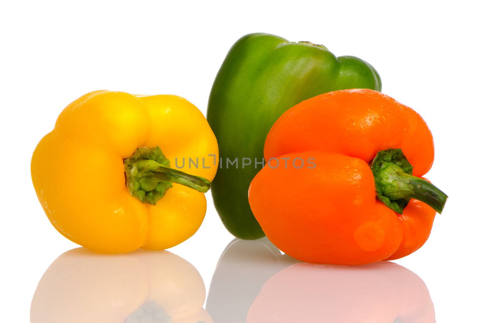 Three fresh peppers on white background.