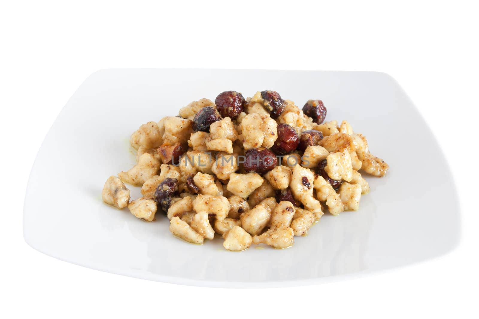plate with chicken and nuts isolated on white background with clipping path