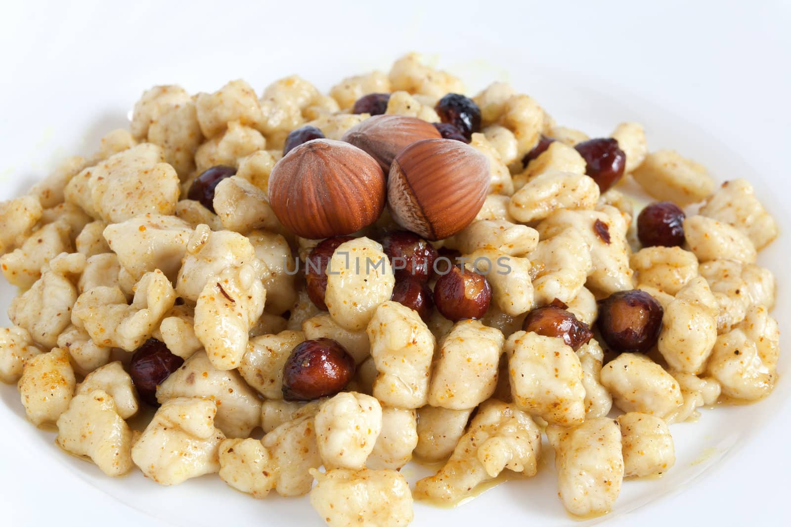 detail of a plate with chicken and nuts with curry sauce
