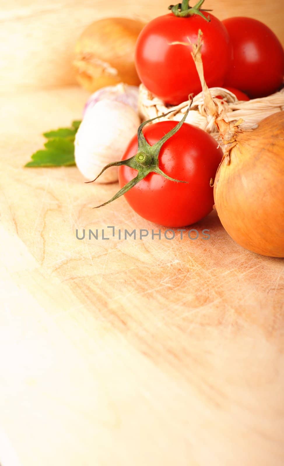tomatoes garlic and other vegetables in kitchen showing healthy food concept