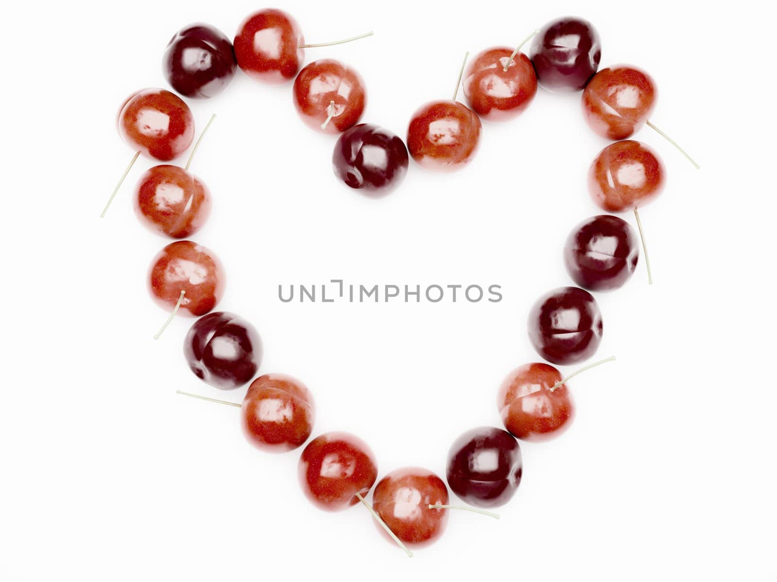 Heart from red cherry on white background