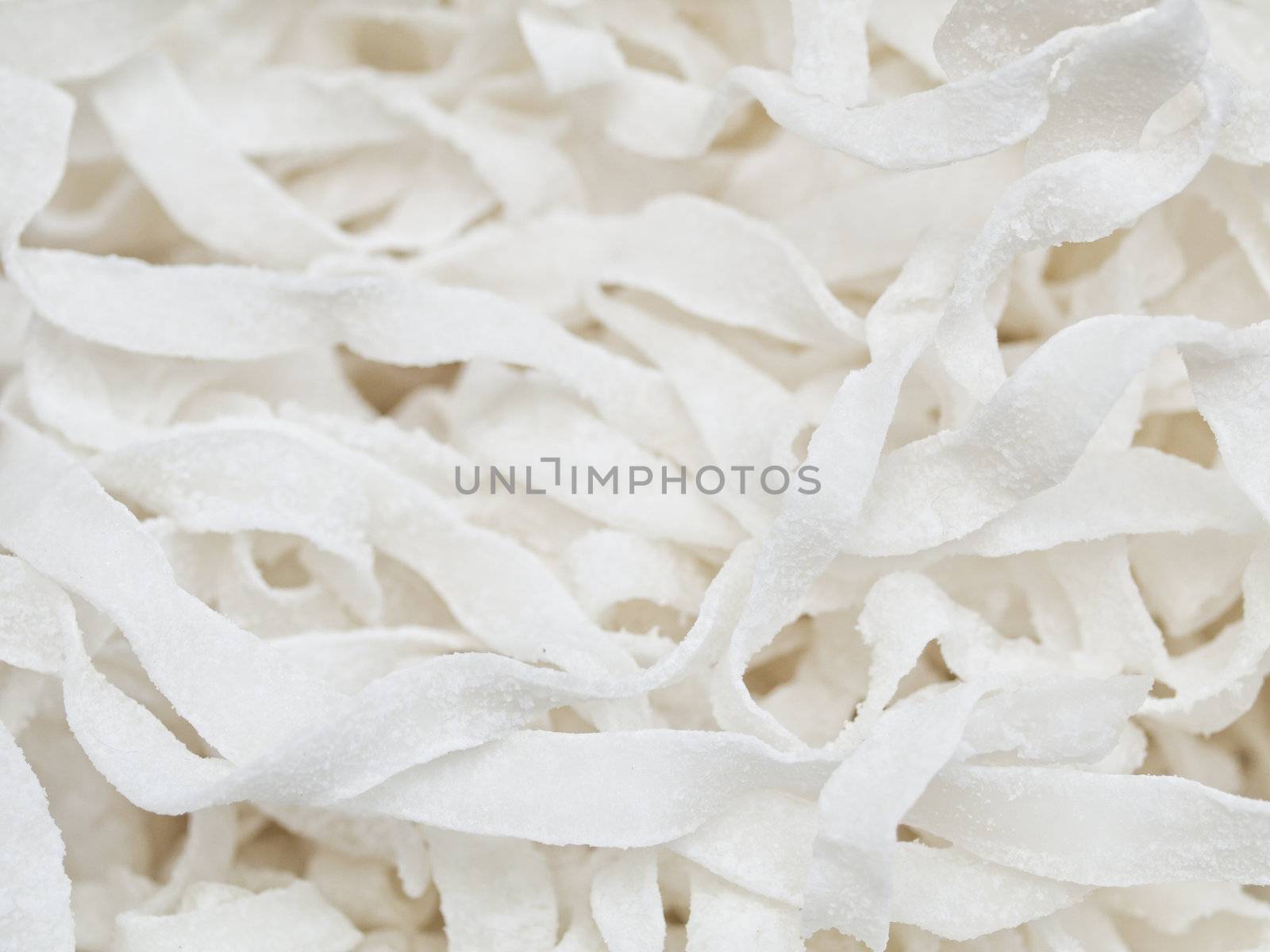 Closeup of a pile of white coconut stripes