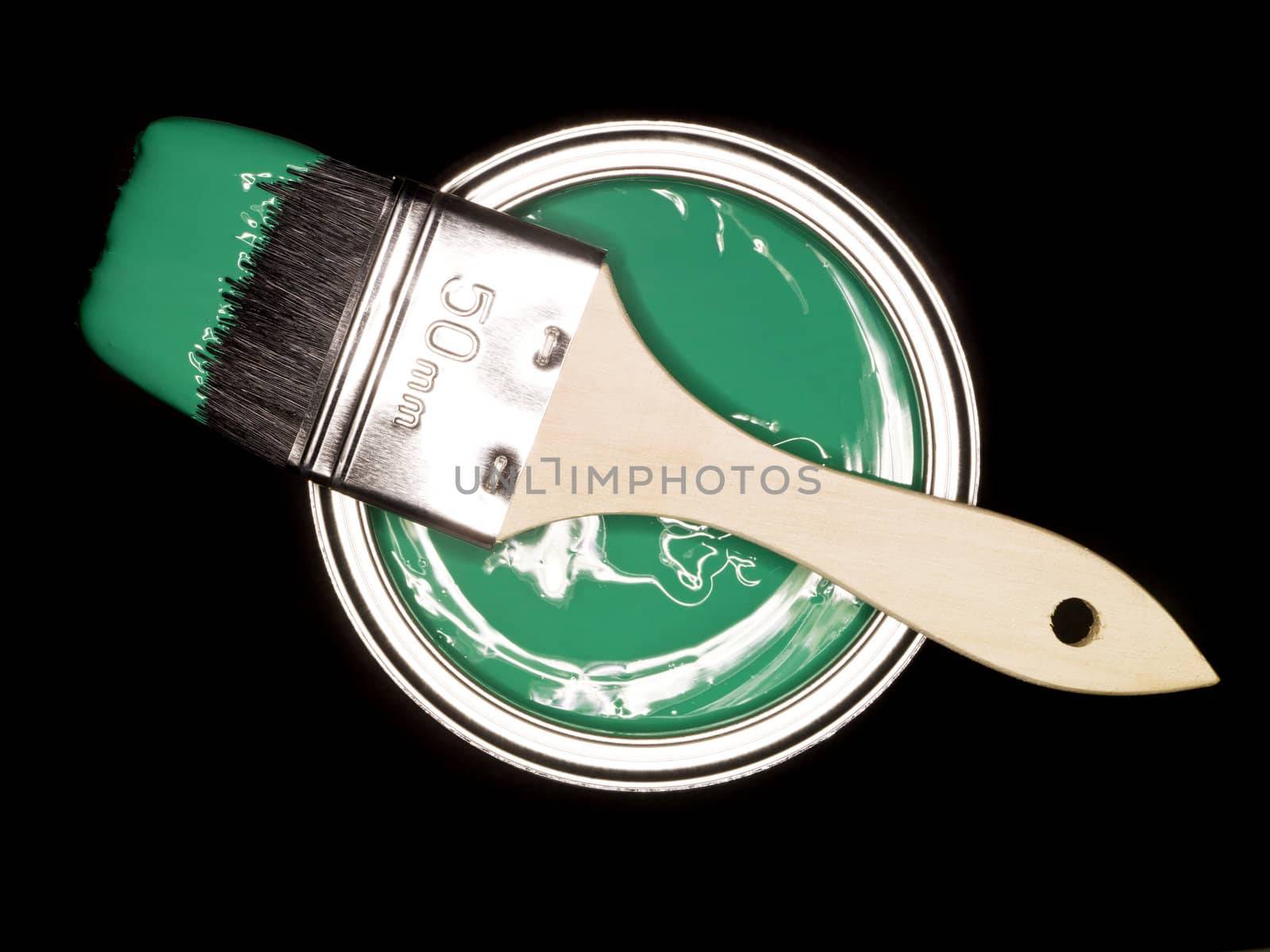 Green Paint can and brush from above on black background