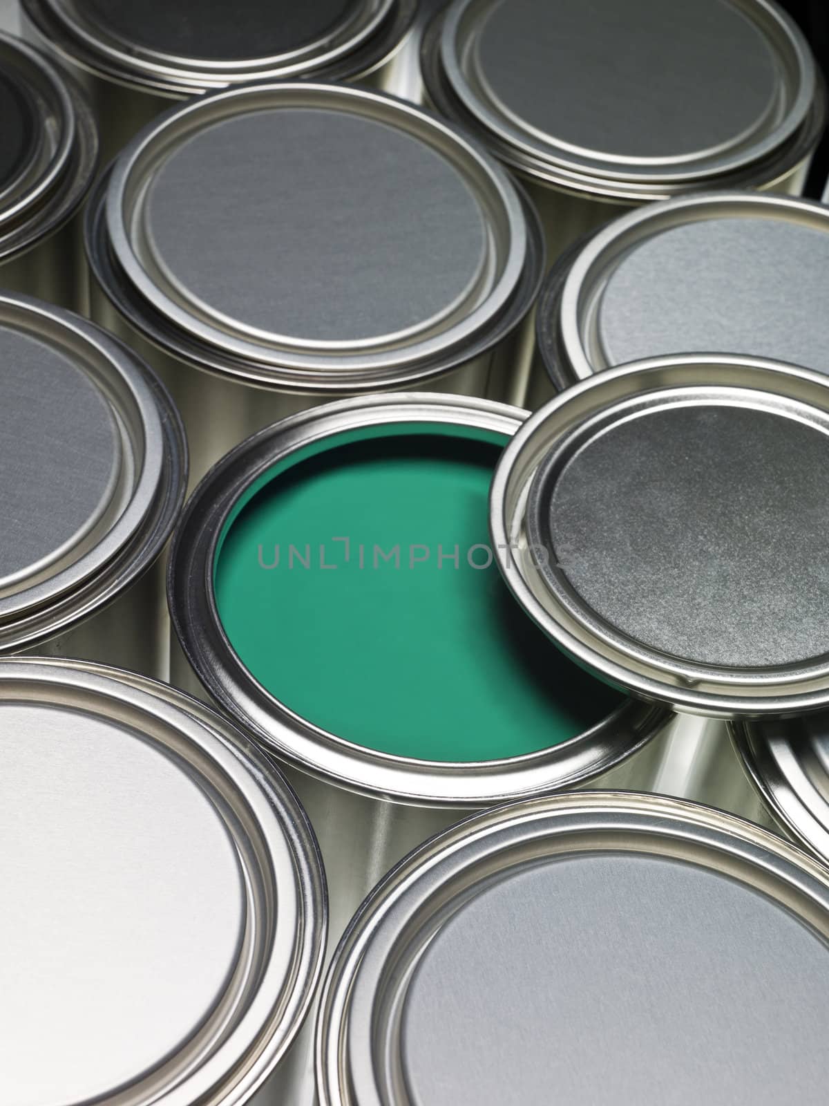 Paint cans full frame with a green can opened