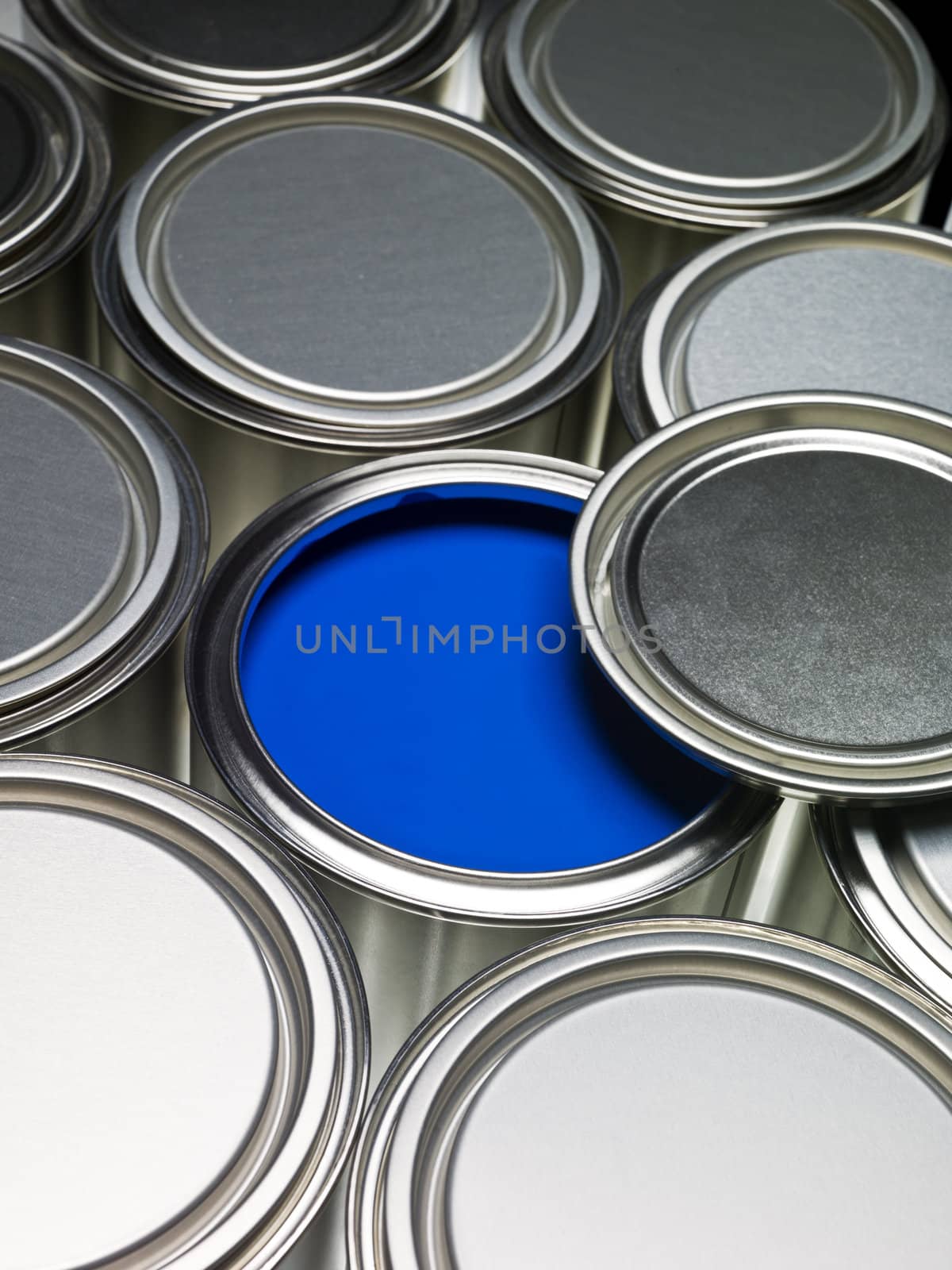 Paint cans full frame with a blue can opened