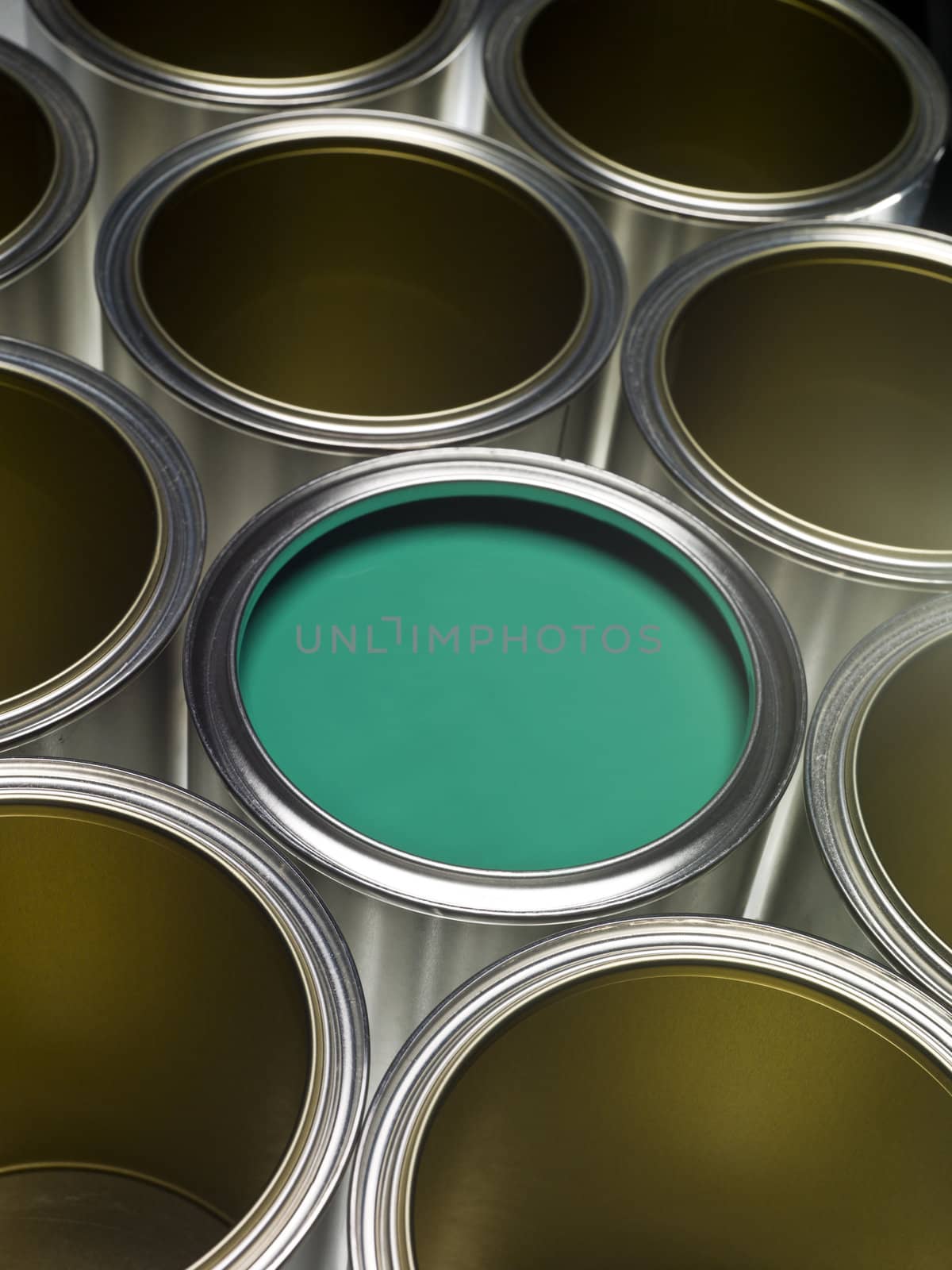 Paint cans full frame with green paint in one of them