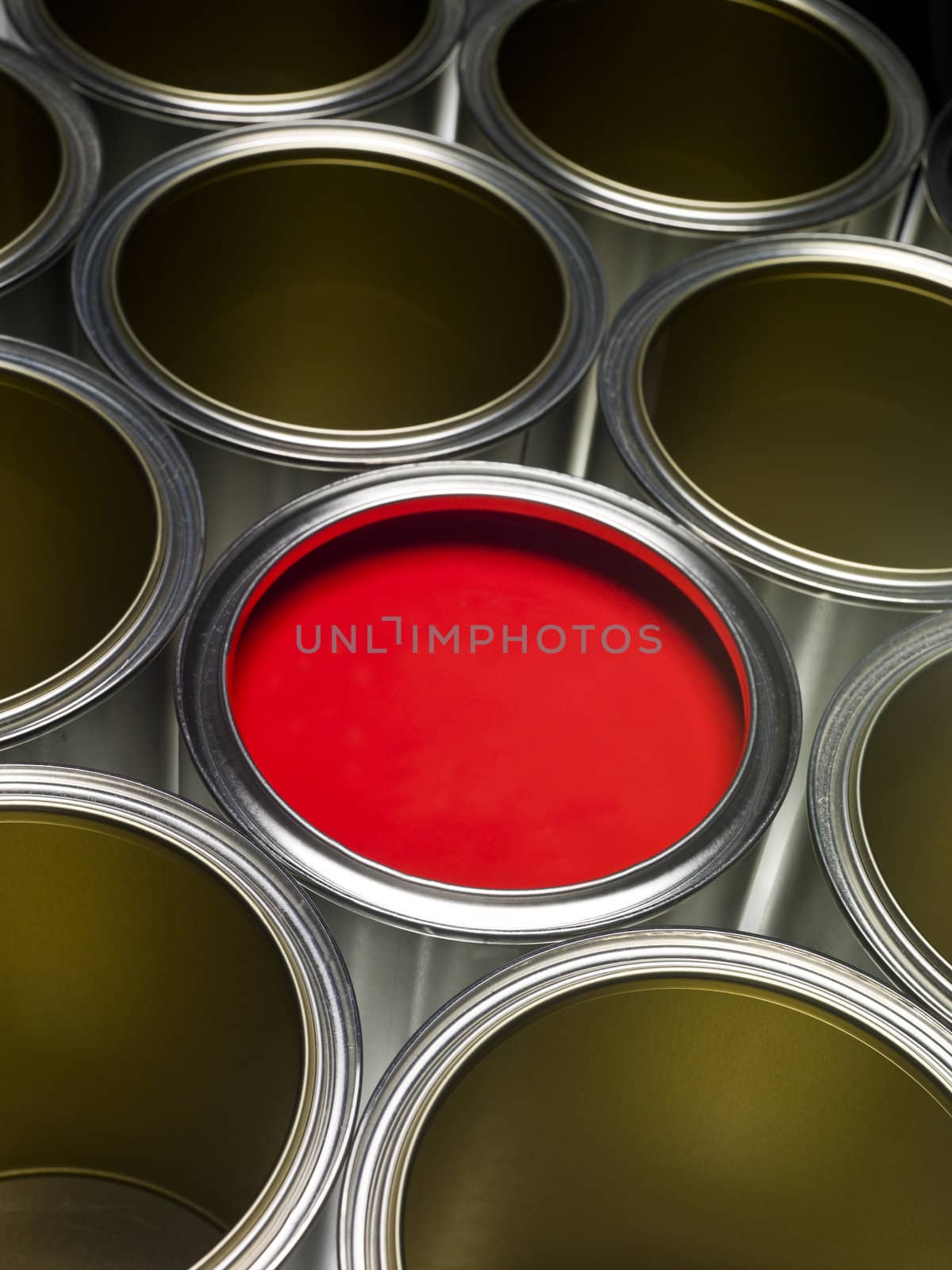 Paint cans full frame with red paint in one of them