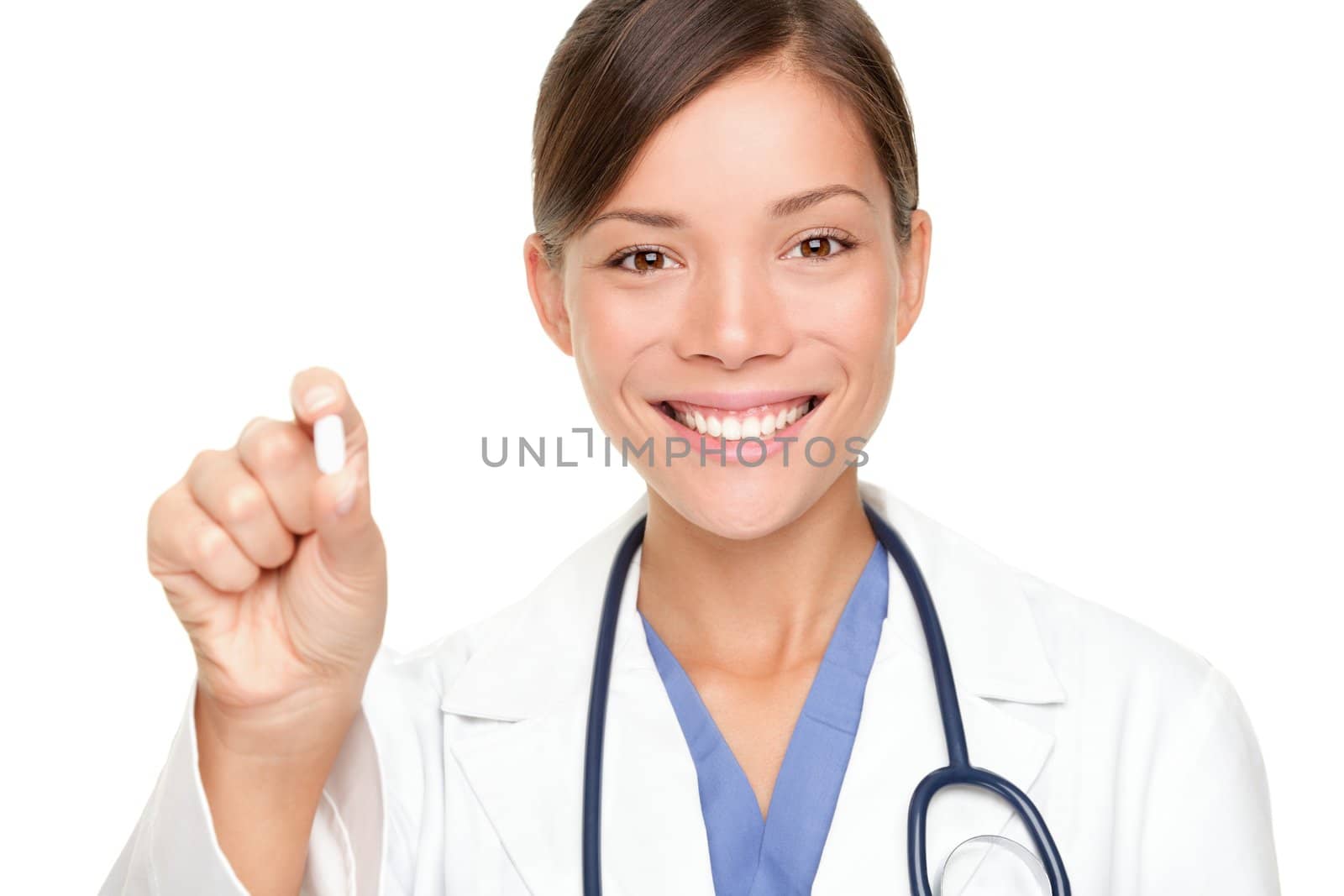 Doctor woman showing pill. Young female medical professional isolated on white background. Multiracial Asian / Caucasian model.