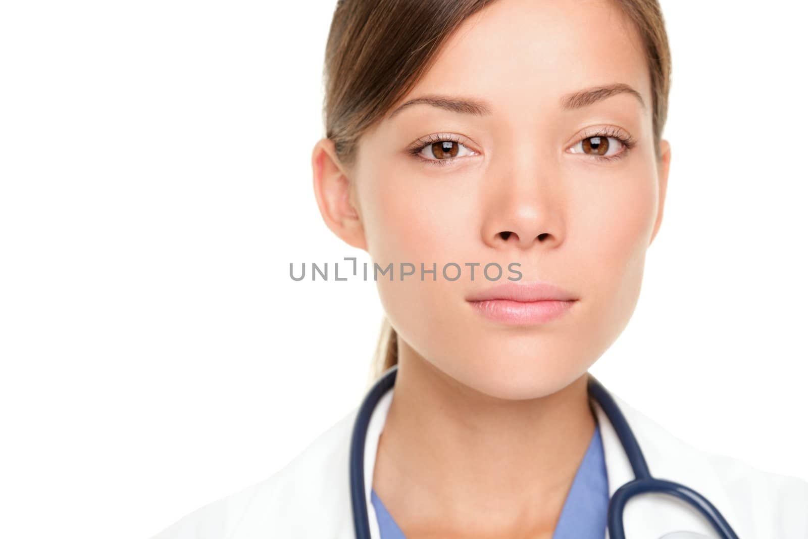 Medical doctor woman with serious expression. Multiracial Asian / Caucasian female medical professional isolated on white background.