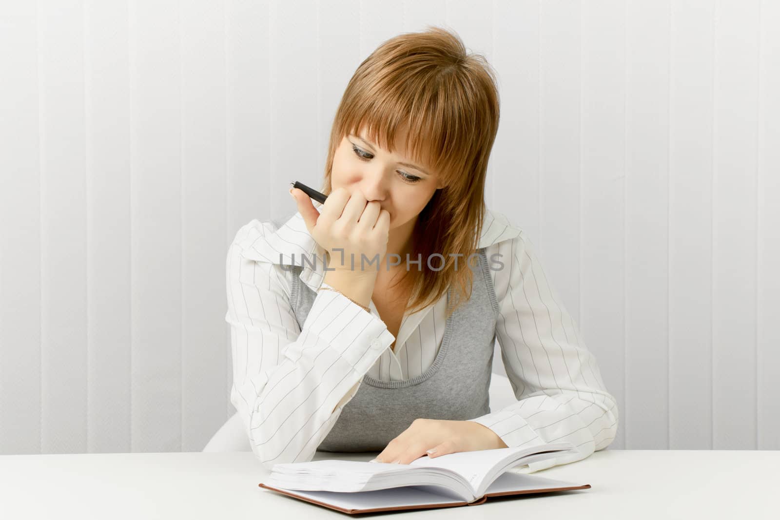 thoughtful girl with a notebook. Secretary in the office.
