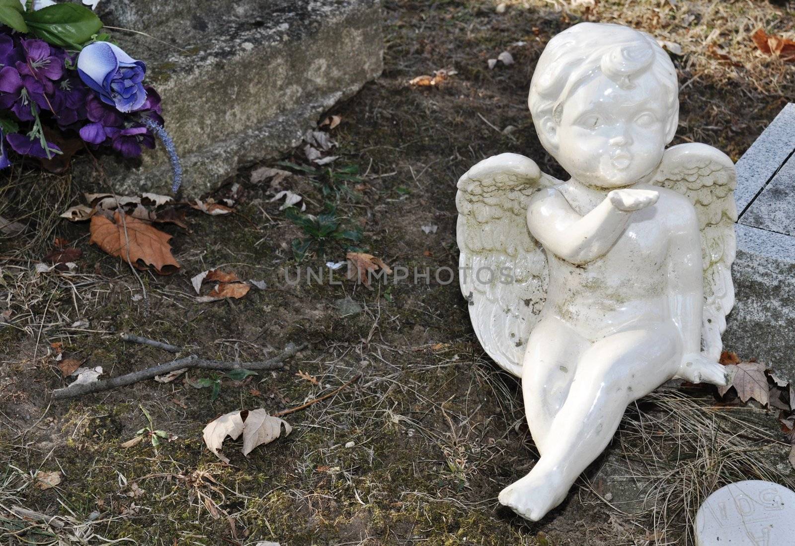 Gravesite - Cherub blowing a kiss - background