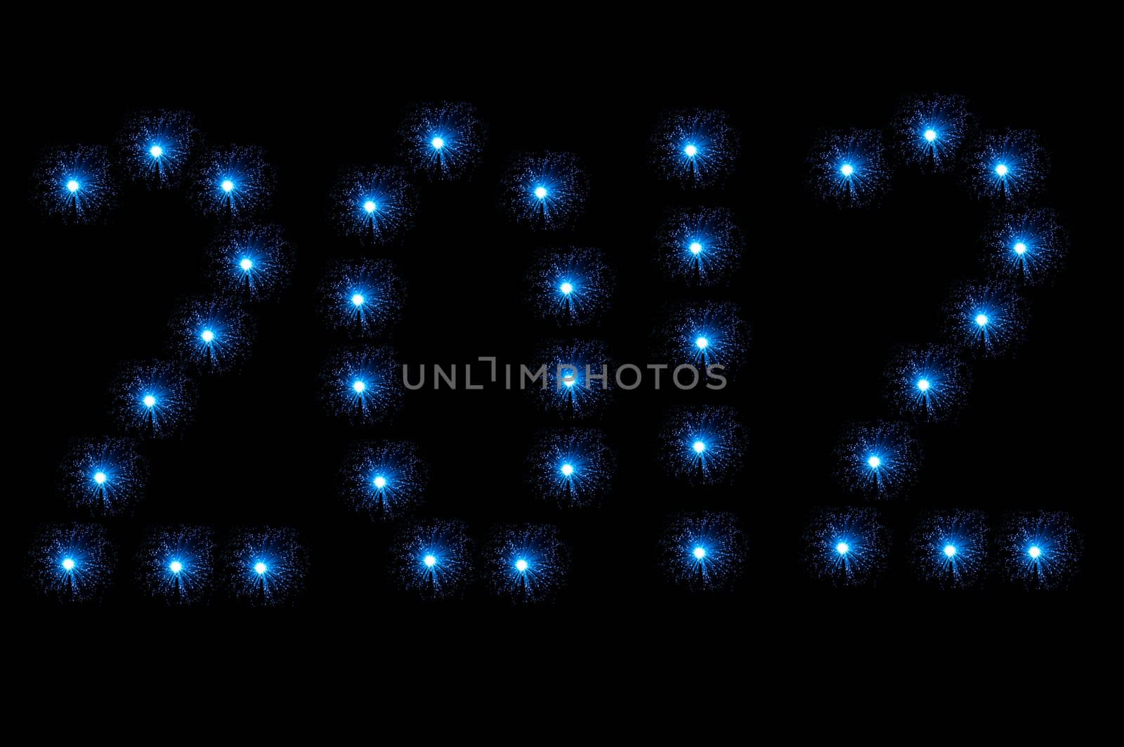 Many small illuminated blue fibre optic lamps arranged on black background to spell the number 2012