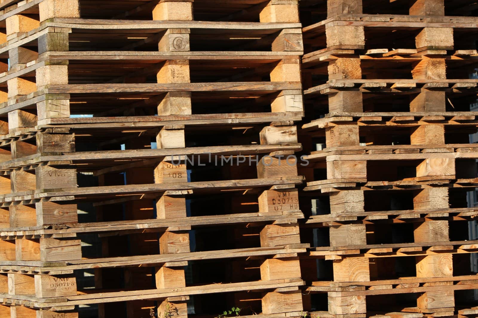 Close up of many brown wood palettes