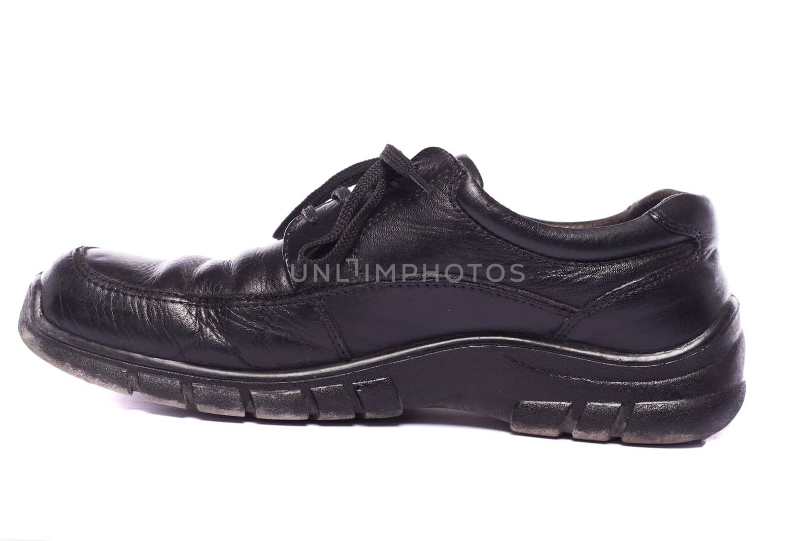 Close up view a modern pair of male black shoes isolated on a white background.