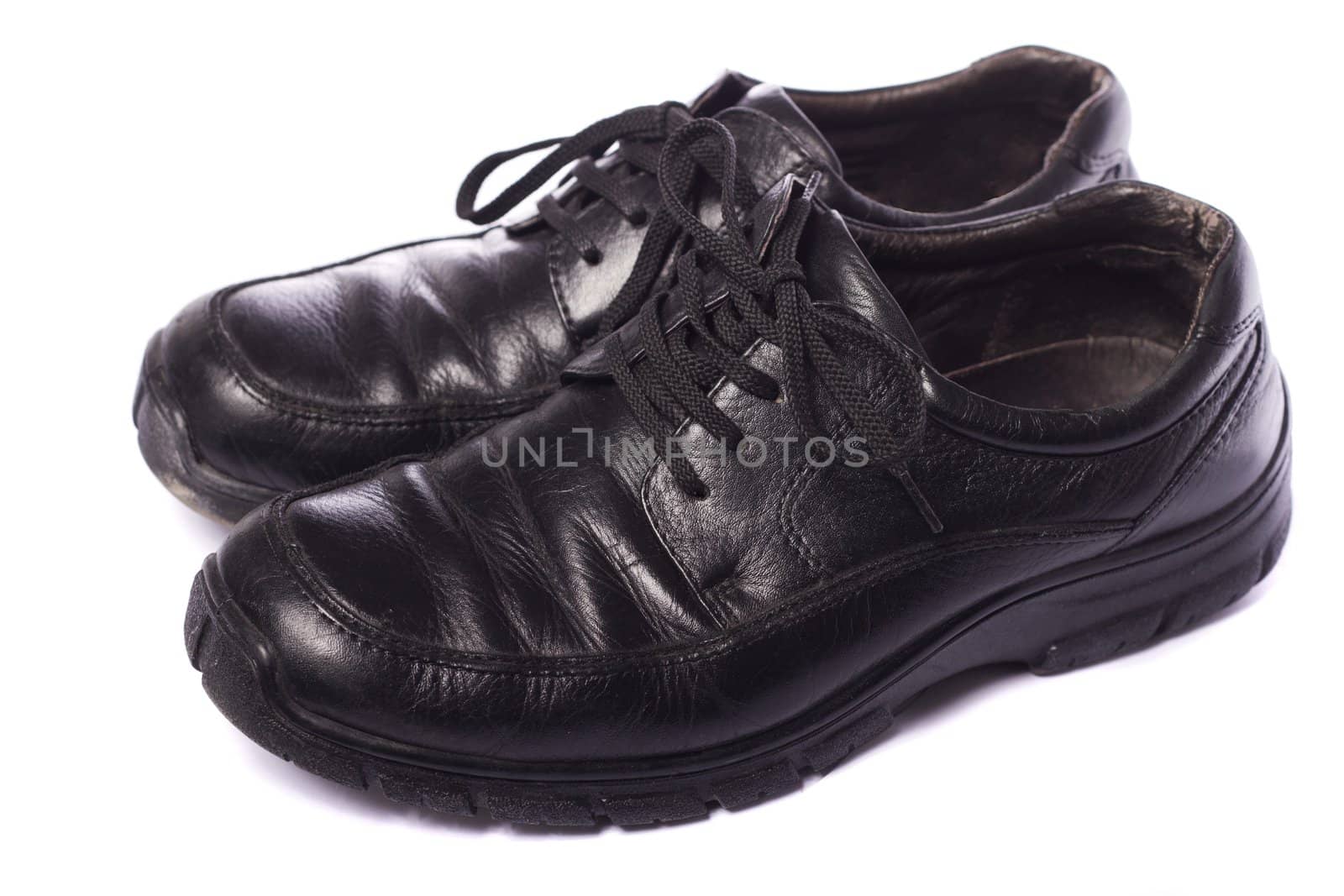 Close up view a modern pair of male black shoes isolated on a white background.