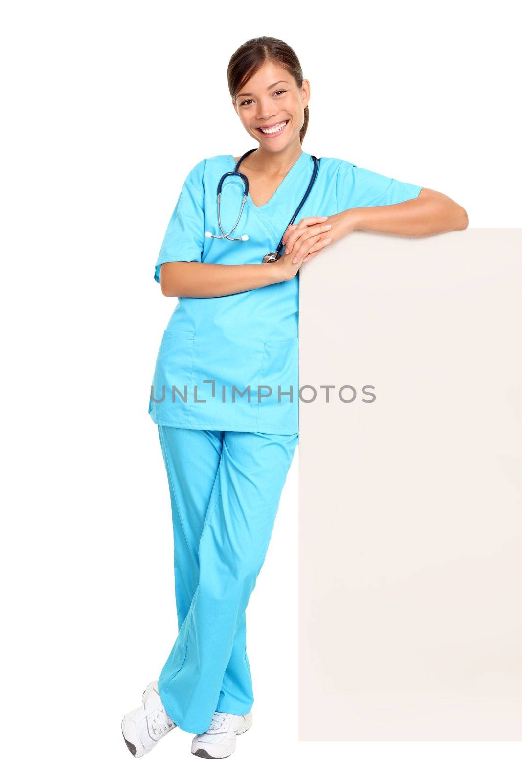 Medical blank sign billboard. Young woman doctor / nurse showing empty sign. Female medical professional standing in full body isolated on white background.