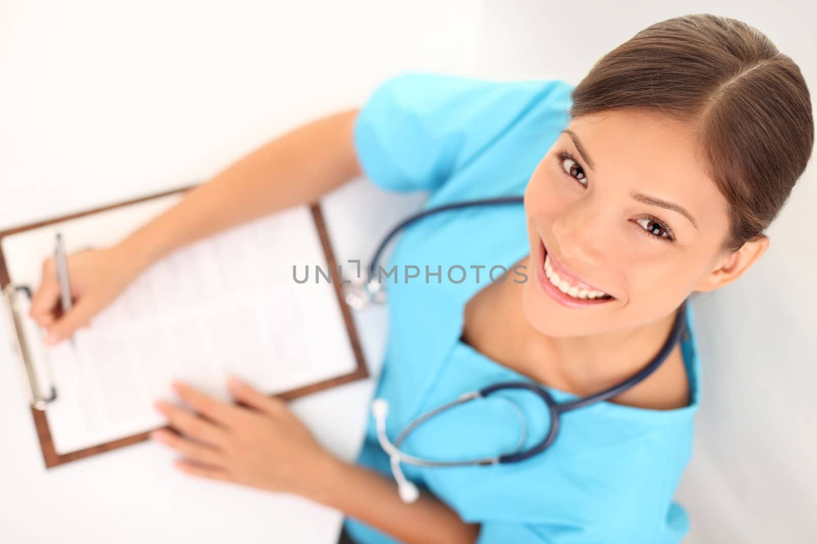 Young medical doctor or woman nurse working. Asian / Caucasian female health care professional.