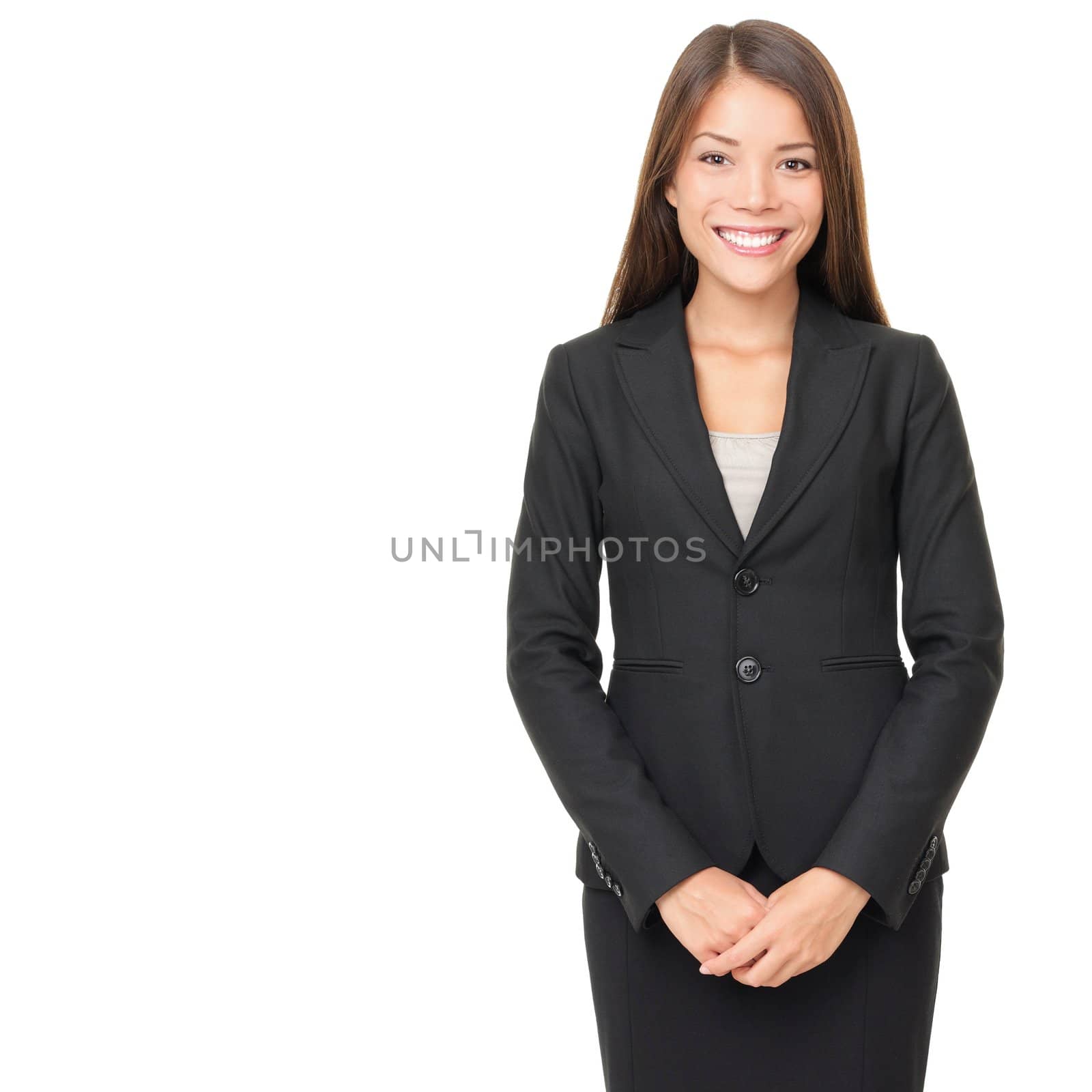 Businesswoman isolated on white background. Young smiling Asian / Caucasian business woman in suit standing looking at camera
