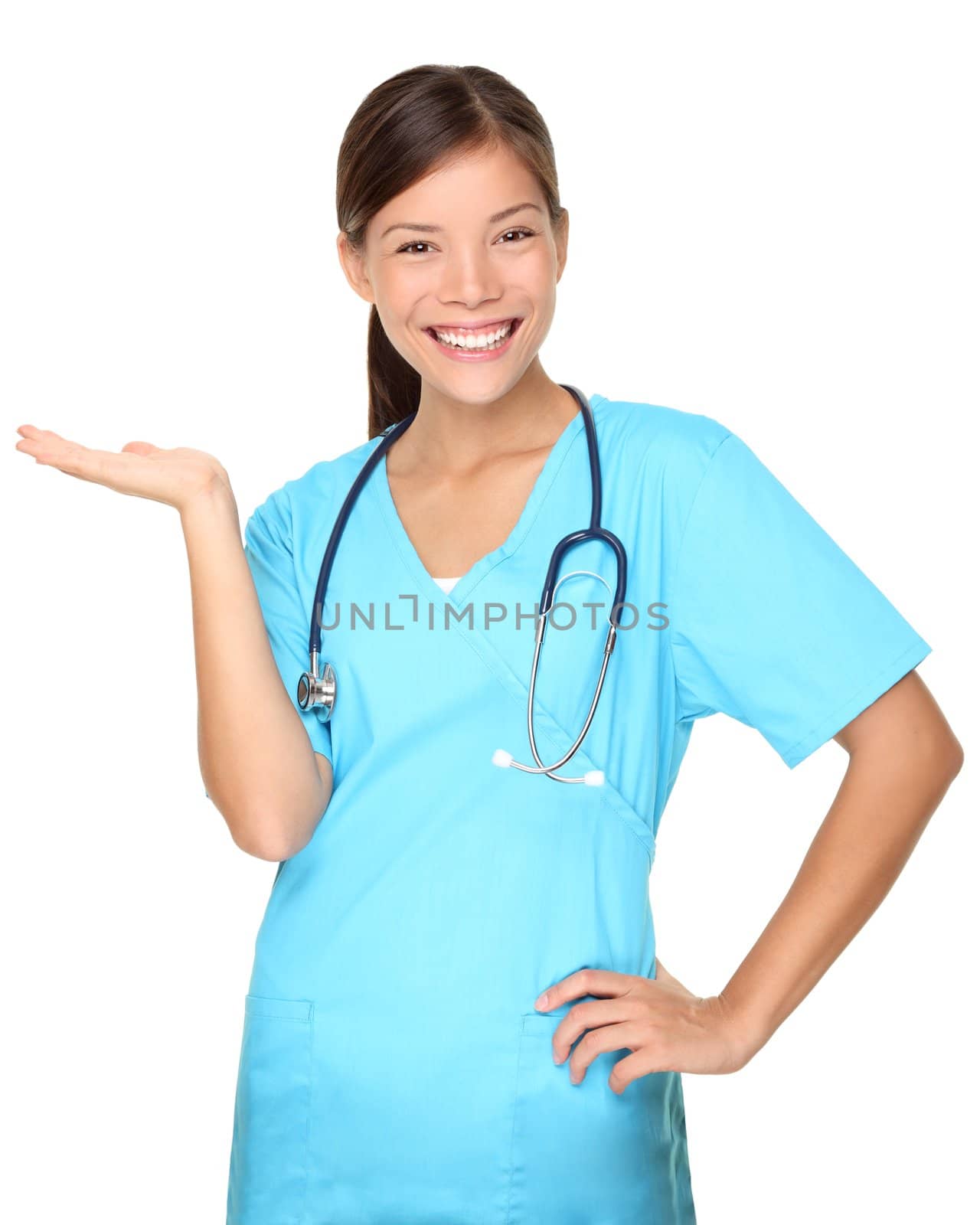 Nurse showing copy space isolated on white background. Beautiful young smiling nurse presenting empty copy space for product or text. Mixed race Asian / Caucasian female model.