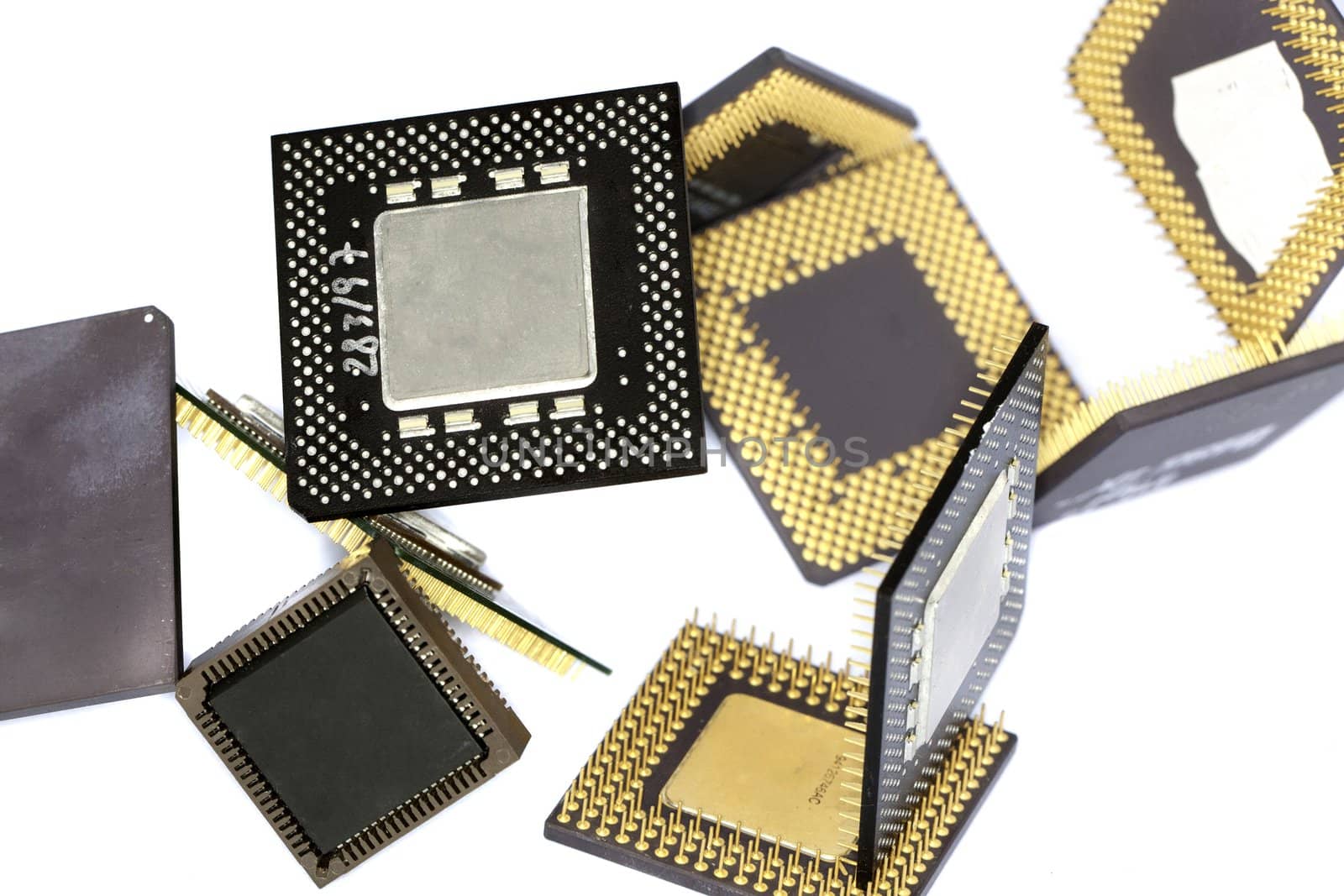 Close view detail of some computer microprocessors isolated on  a white background.