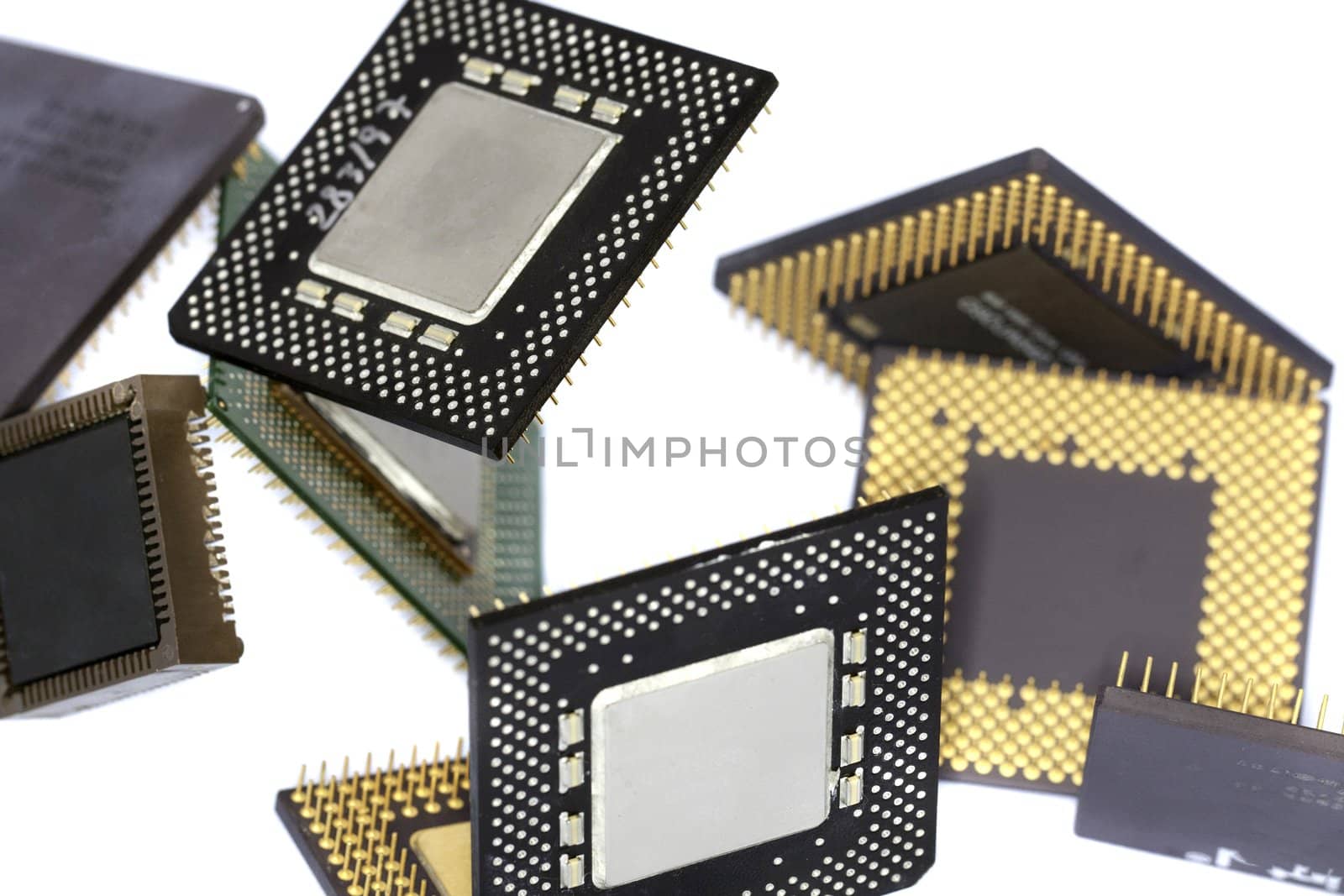 Close view detail of some computer microprocessors isolated on  a white background.