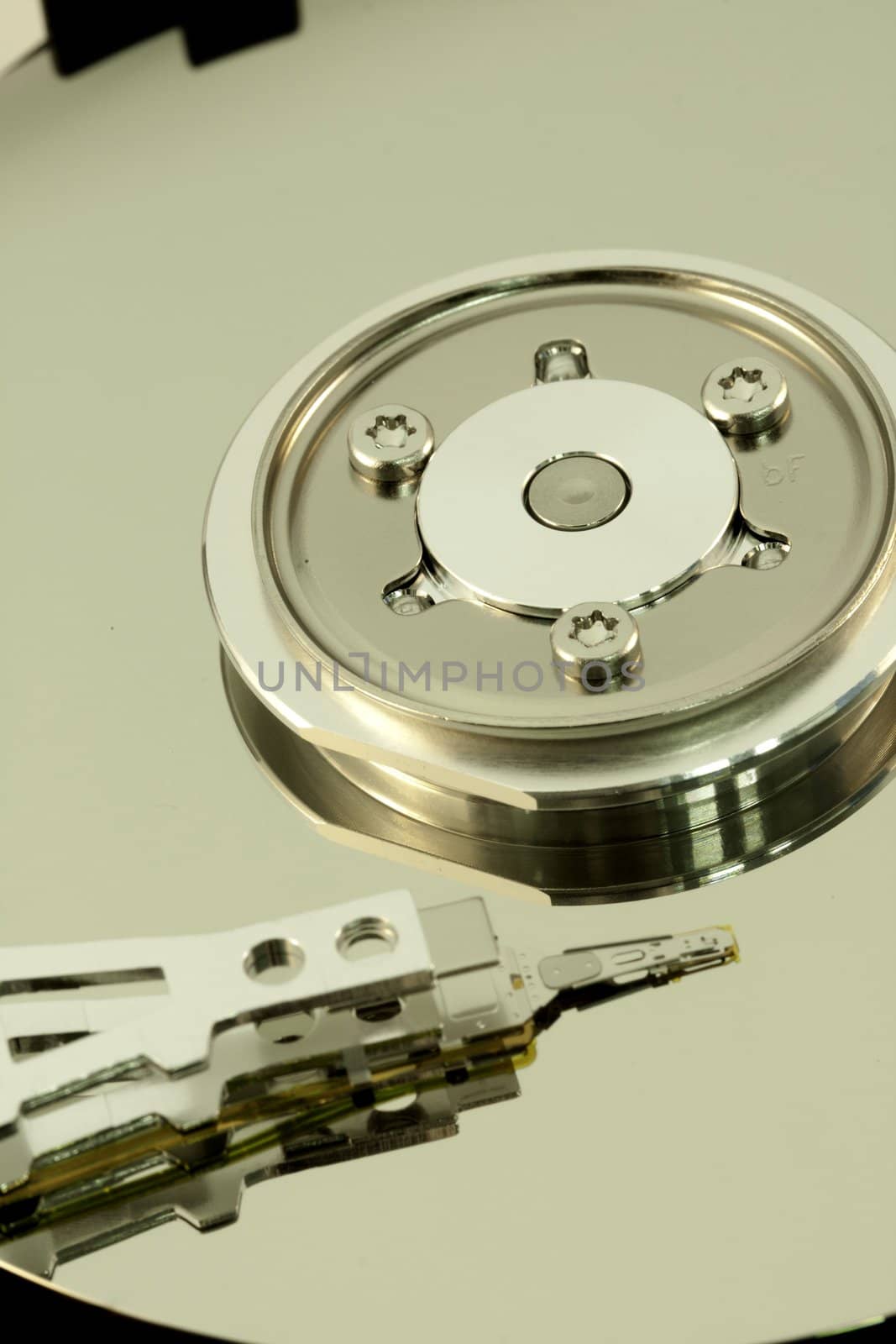 close view detail of the inside of a computer harddisk isolated on a white background.