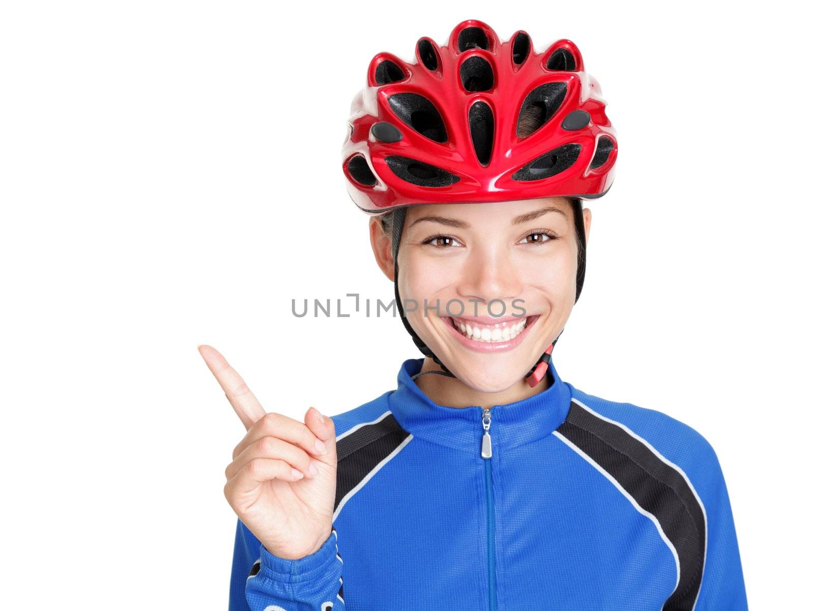 Bike woman wearing bicycle helmet pointing at copy space isolated on white background. Beautiful young asian chinese / white caucasian woman in biking outfit and red biking helmet