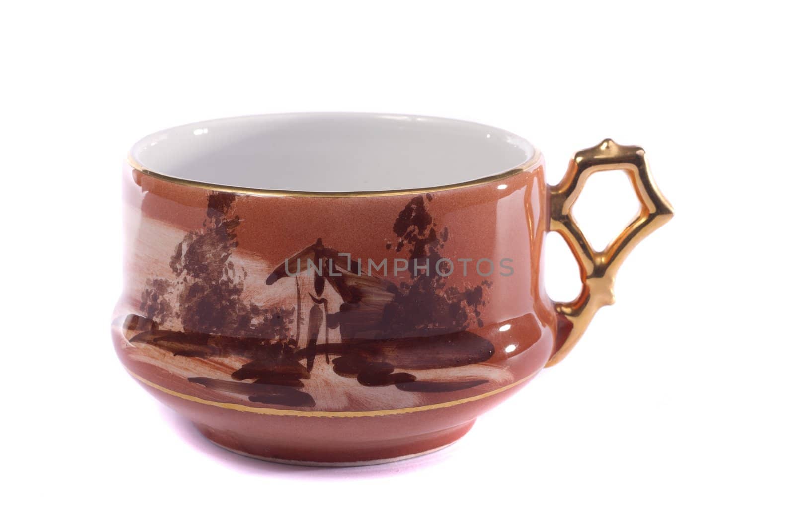 Close up view of an old retro mug for drinking tea isolated on a white background.
