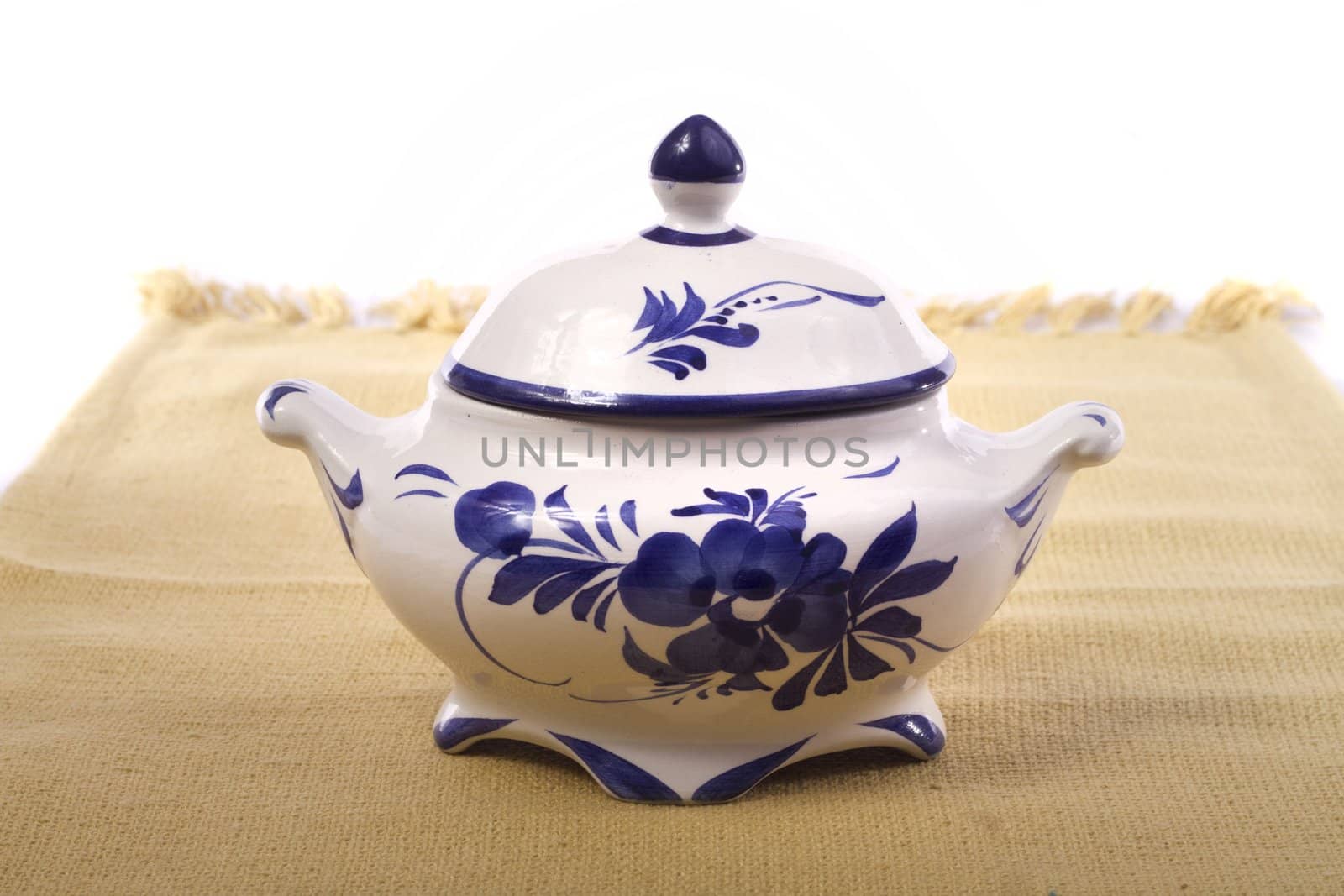 Close up detail of a tea pot isolated on a white background.