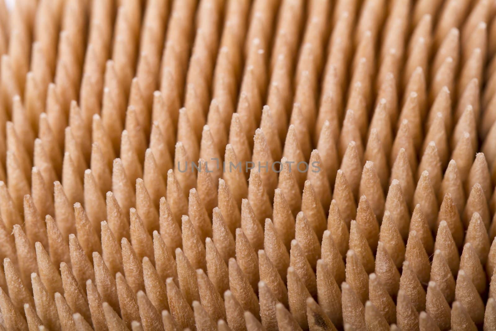 Macro view of a bunch of toothpicks inside a container.