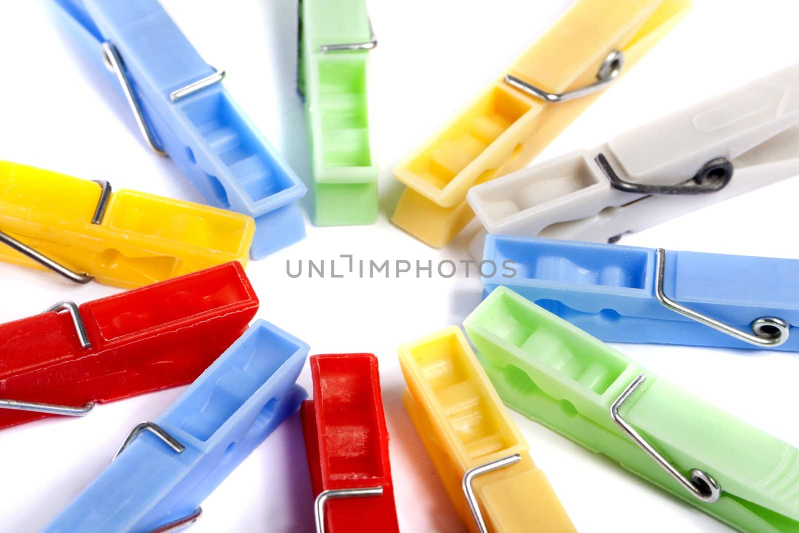 Close up view of some colorful cloth pegs isolated on a white background.