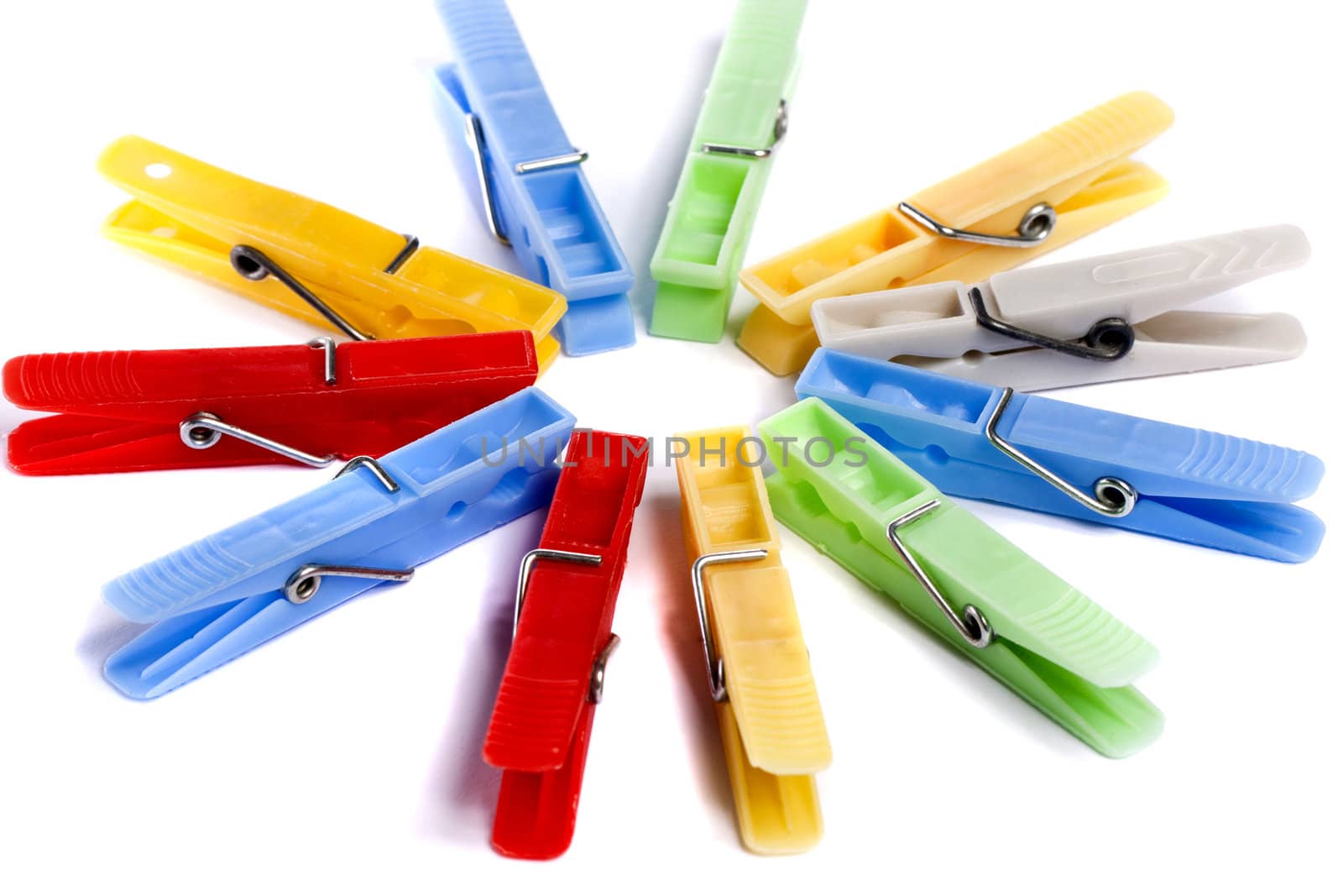 Close up view of some colorful cloth pegs isolated on a white background.