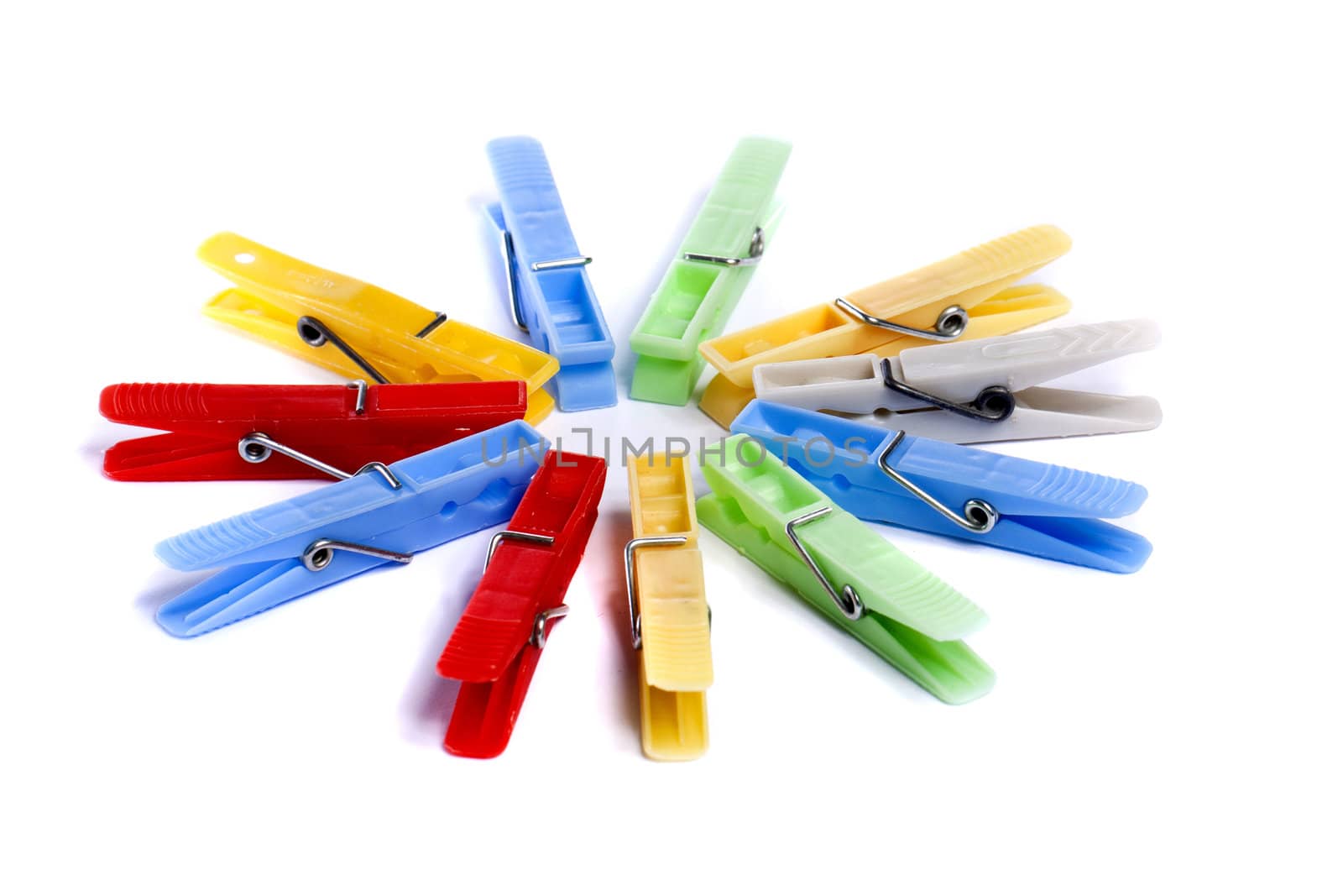 Close up view of some colorful cloth pegs isolated on a white background.