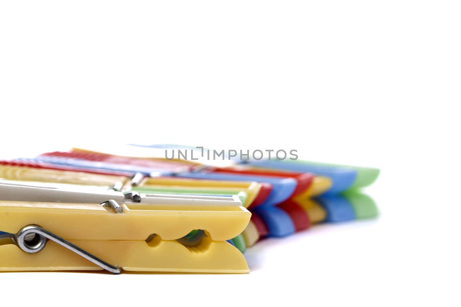 Close up view of some colorful cloth pegs isolated on a white background.