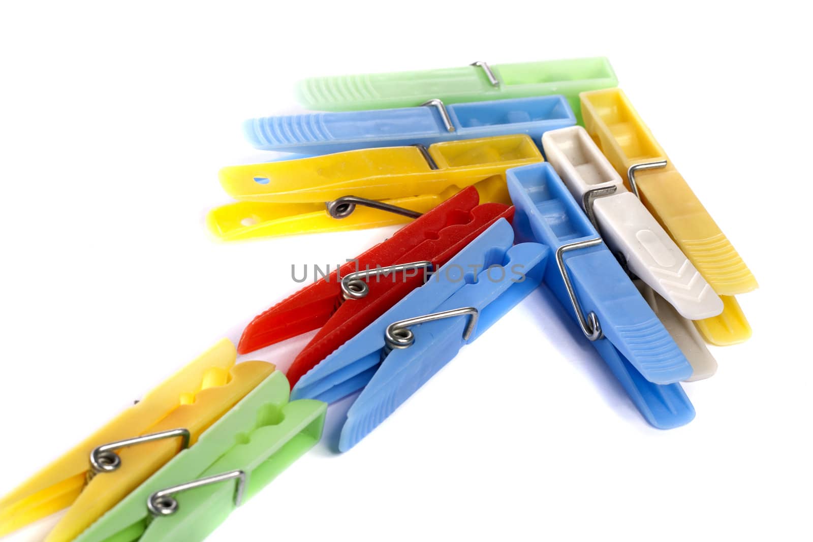 Close up view of some colorful cloth pegs isolated on a white background.